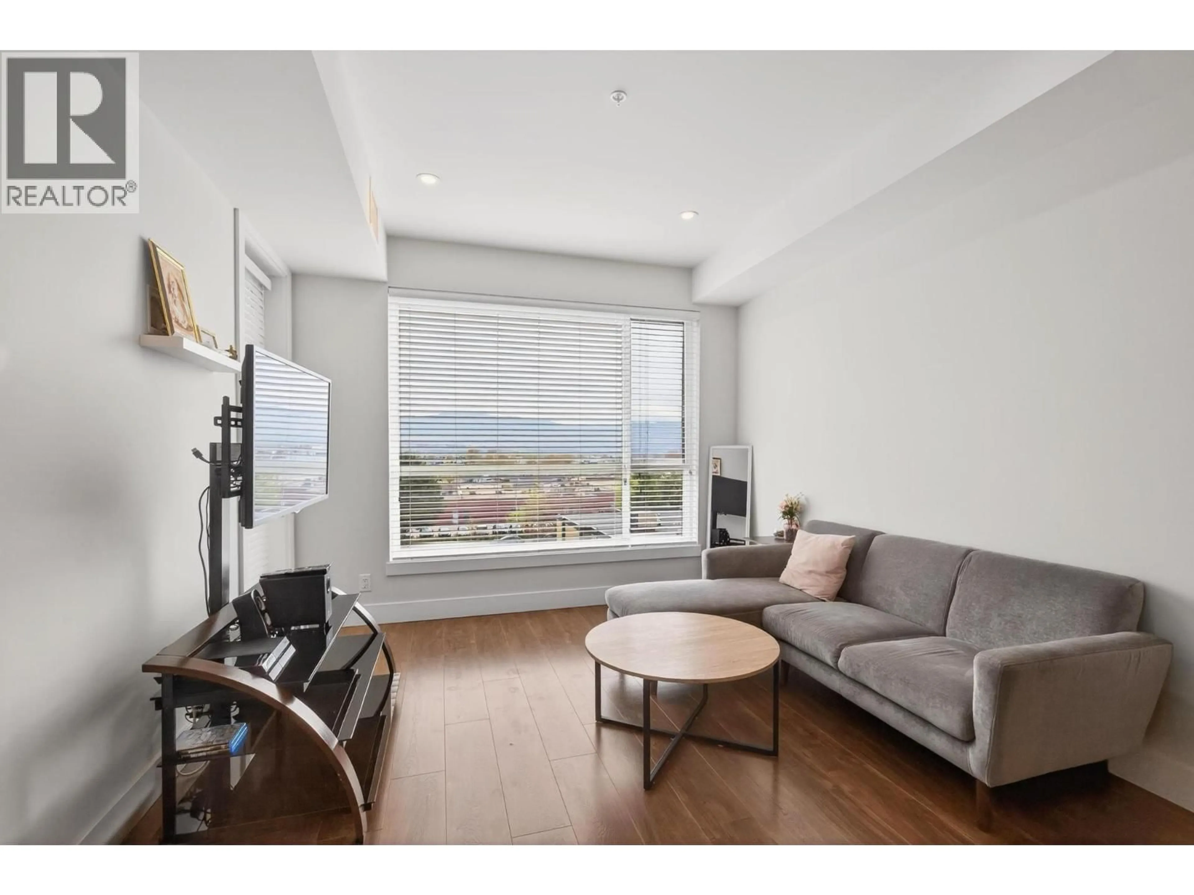 Living room with furniture, wood/laminate floor for 412 - 1925 ENTERPRISE WAY, Kelowna British Columbia V1Y0J8