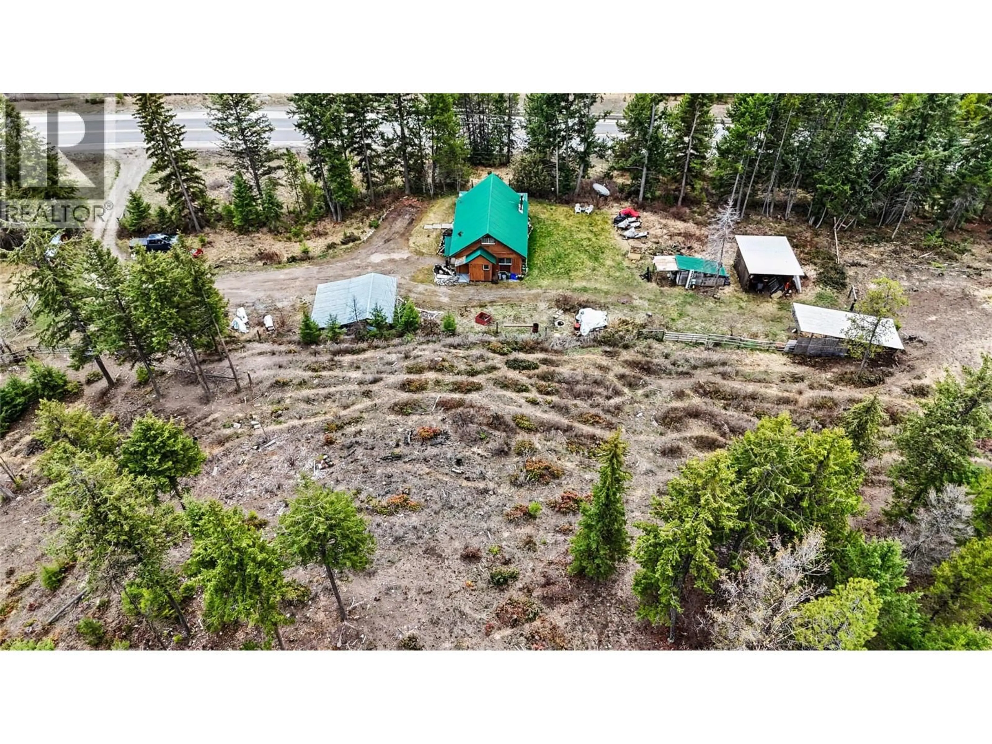 A pic from outside/outdoor area/front of a property/back of a property/a pic from drone, forest/trees view for 12050 3 HIGHWAY, Greenwood British Columbia V0H1J0