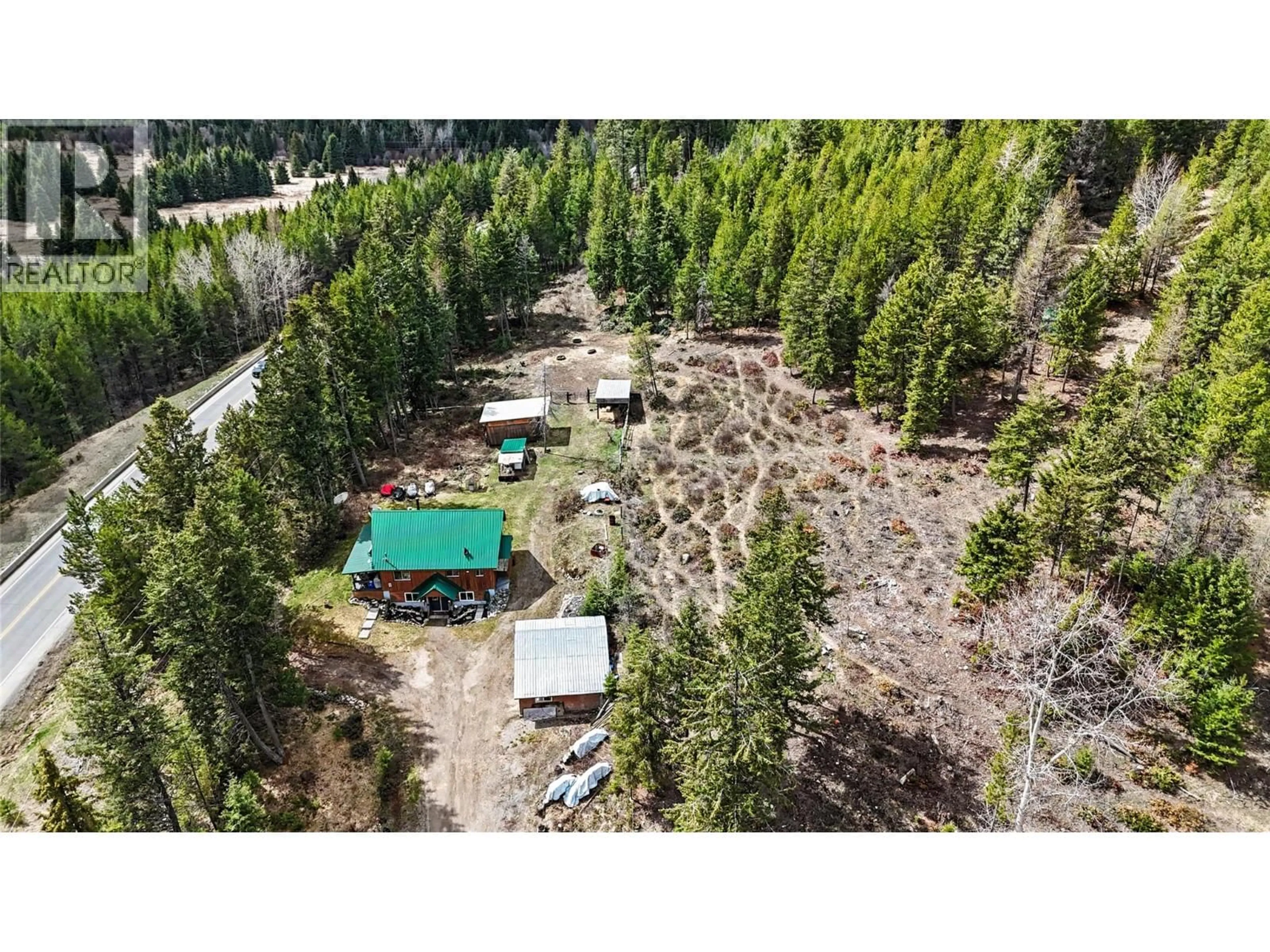 A pic from outside/outdoor area/front of a property/back of a property/a pic from drone, forest/trees view for 12050 3 HIGHWAY, Greenwood British Columbia V0H1J0