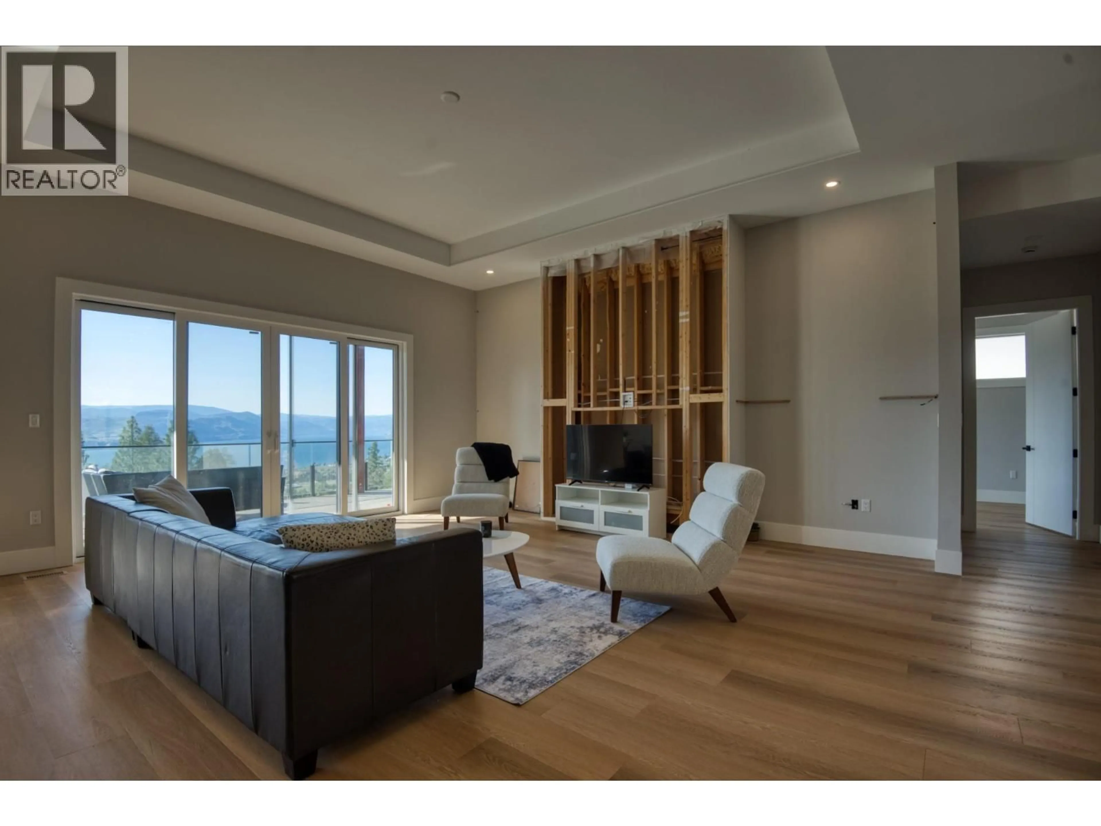 Living room with furniture, wood/laminate floor for 2835 OUTLOOK WAY, Naramata British Columbia V0H1N1