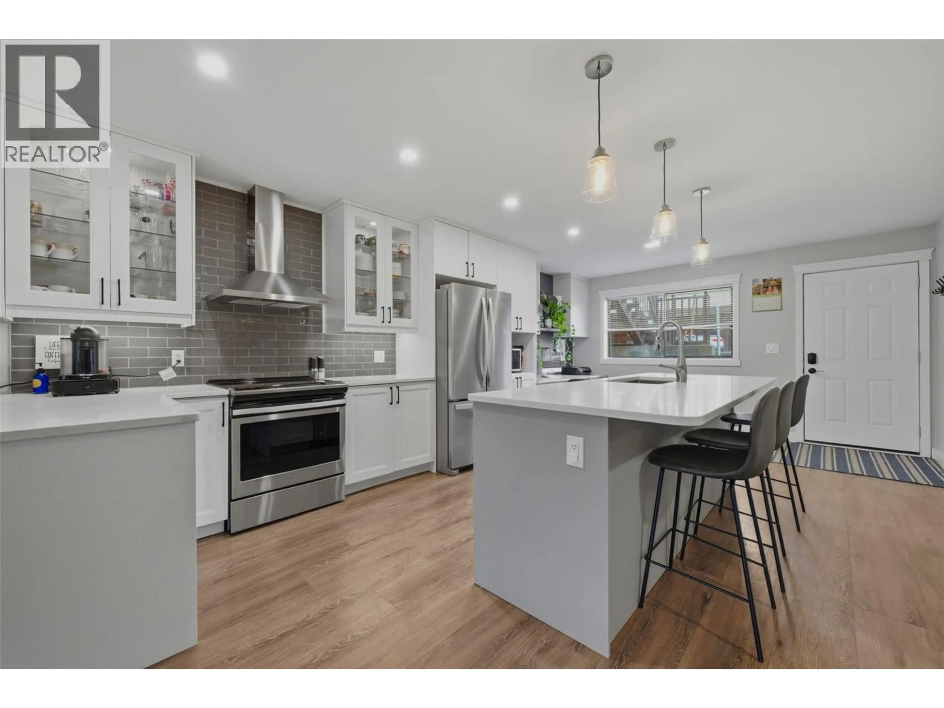 Open concept kitchen, wood/laminate floor for 106 - 3020 ALLENBY WAY, Vernon British Columbia V1T8L4