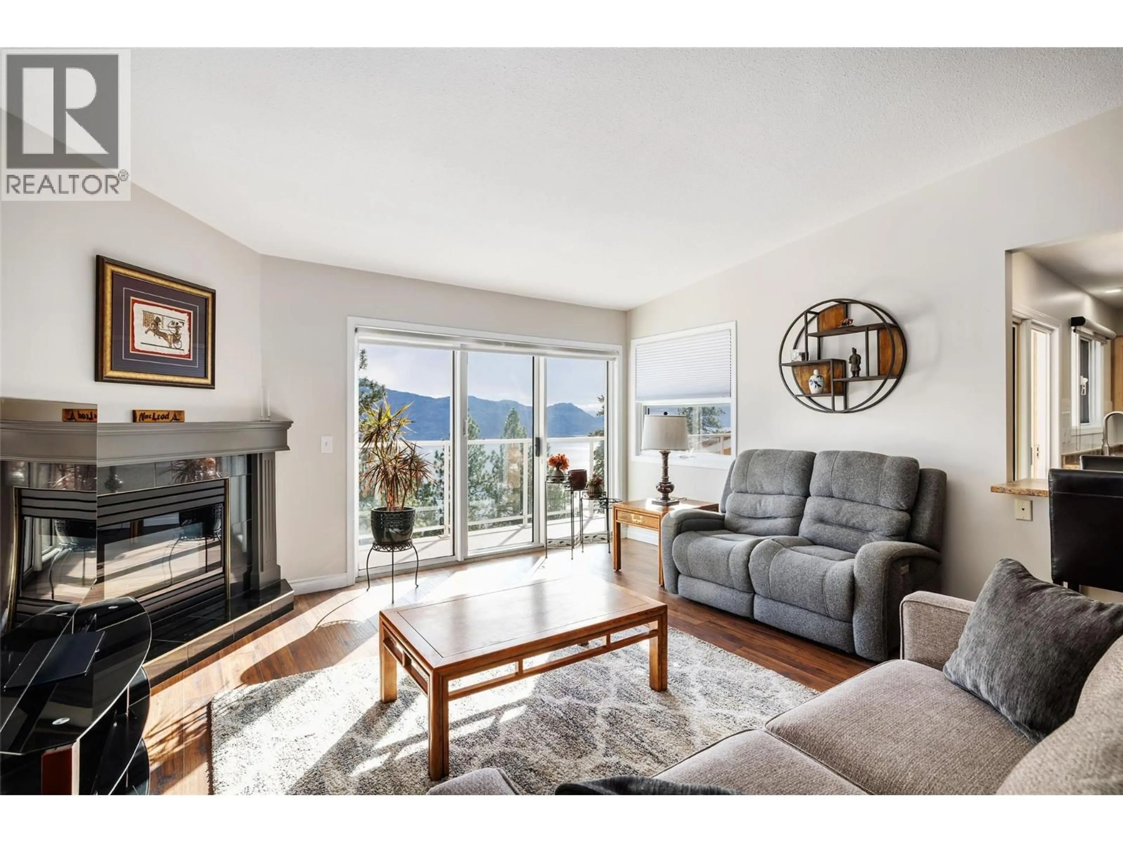 Living room with furniture, wood/laminate floor for 204 - 4450 PONDEROSA DRIVE, Peachland British Columbia V0H1X5