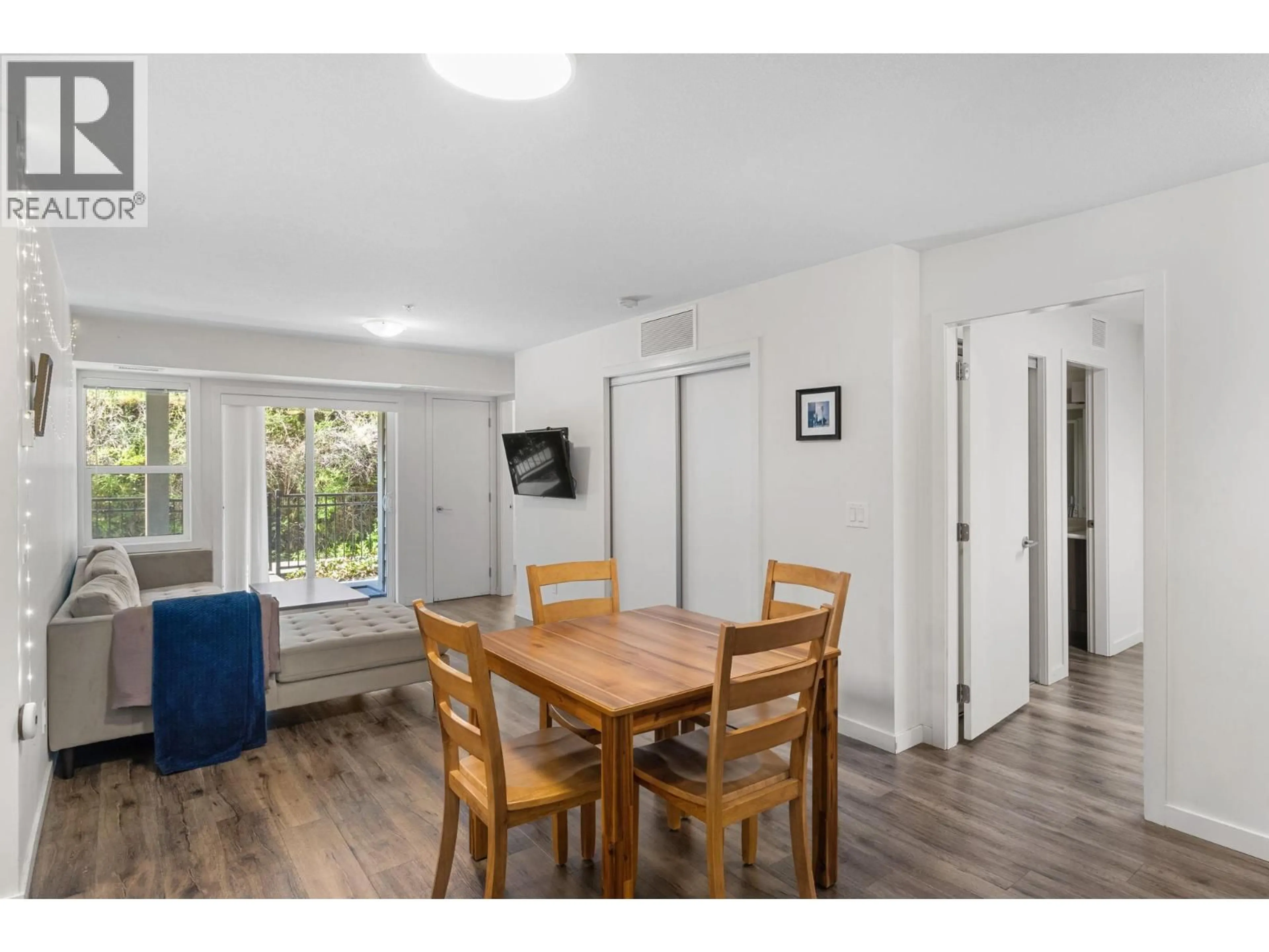 Dining room, wood/laminate floor for 110 - 655 ACADEMY WAY, Kelowna British Columbia V1V3A4