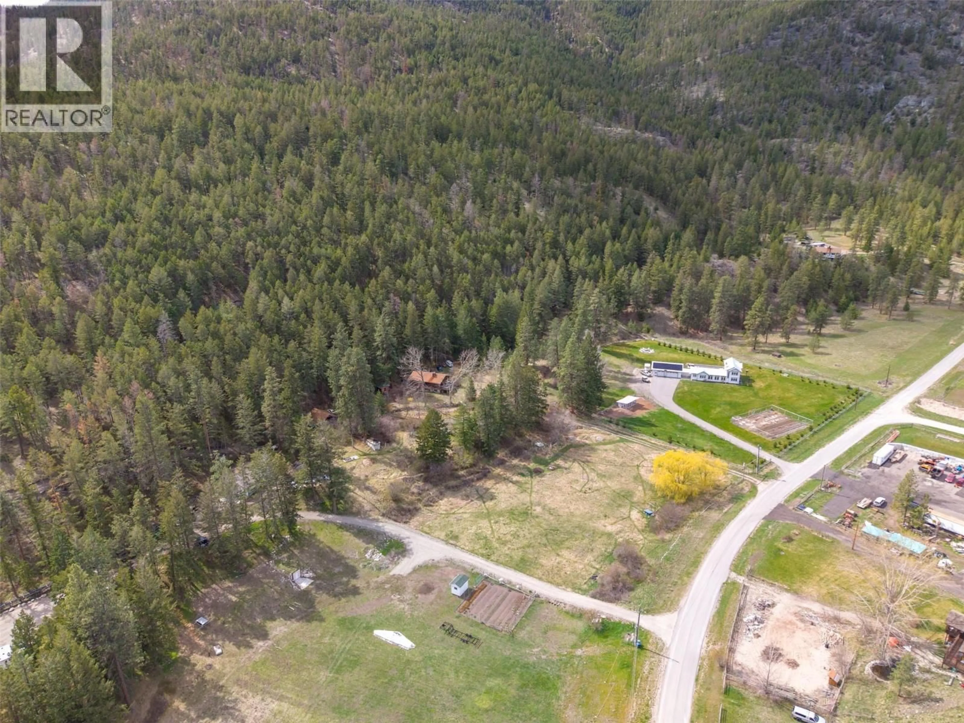 A pic from outside/outdoor area/front of a property/back of a property/a pic from drone, forest/trees view for 128 FARLEIGH LAKE ROAD, Penticton British Columbia V2A0E6