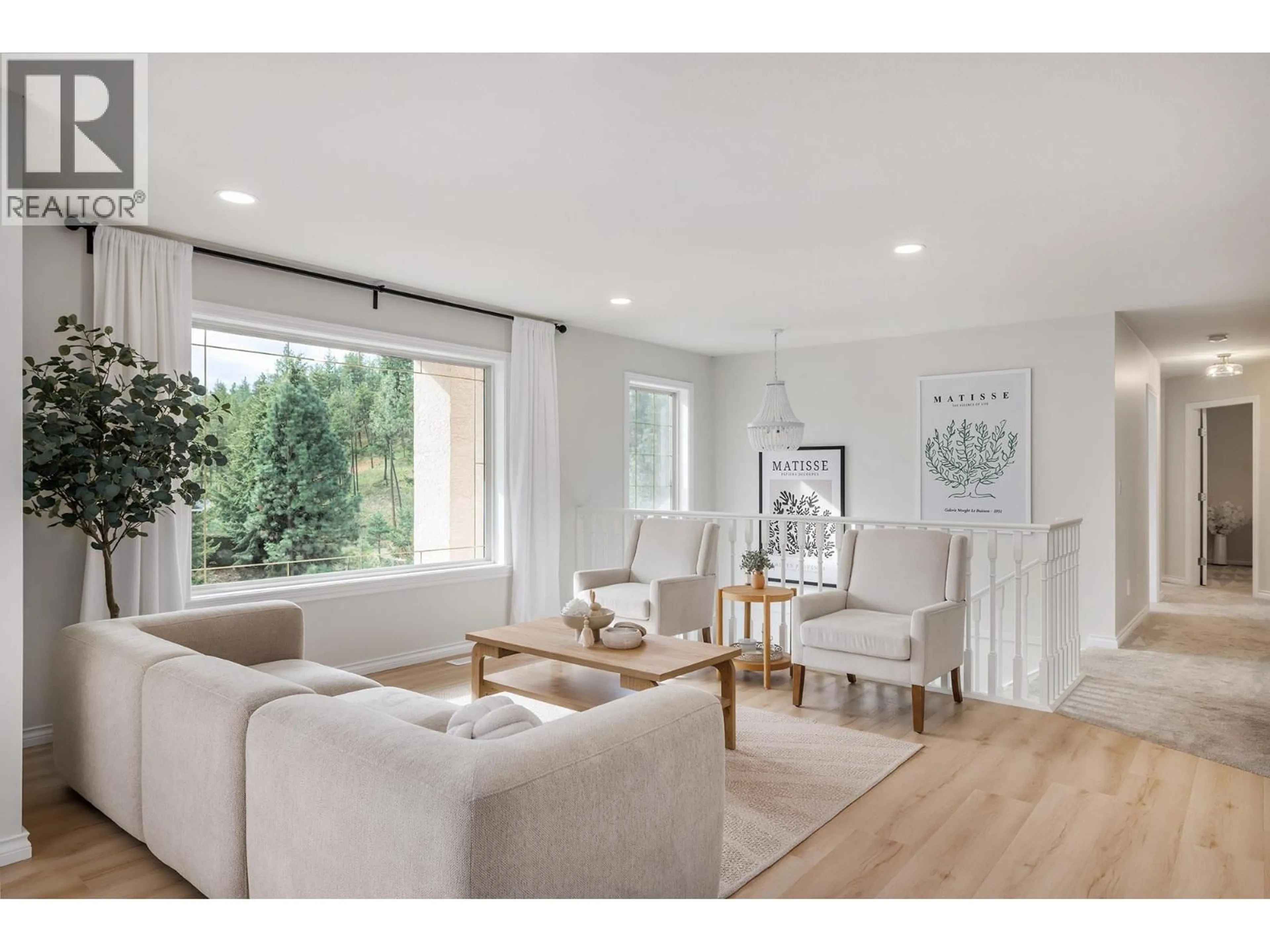 Living room with furniture, wood/laminate floor for 2321 LILLOOET CRESCENT, Kelowna British Columbia V1V1T1