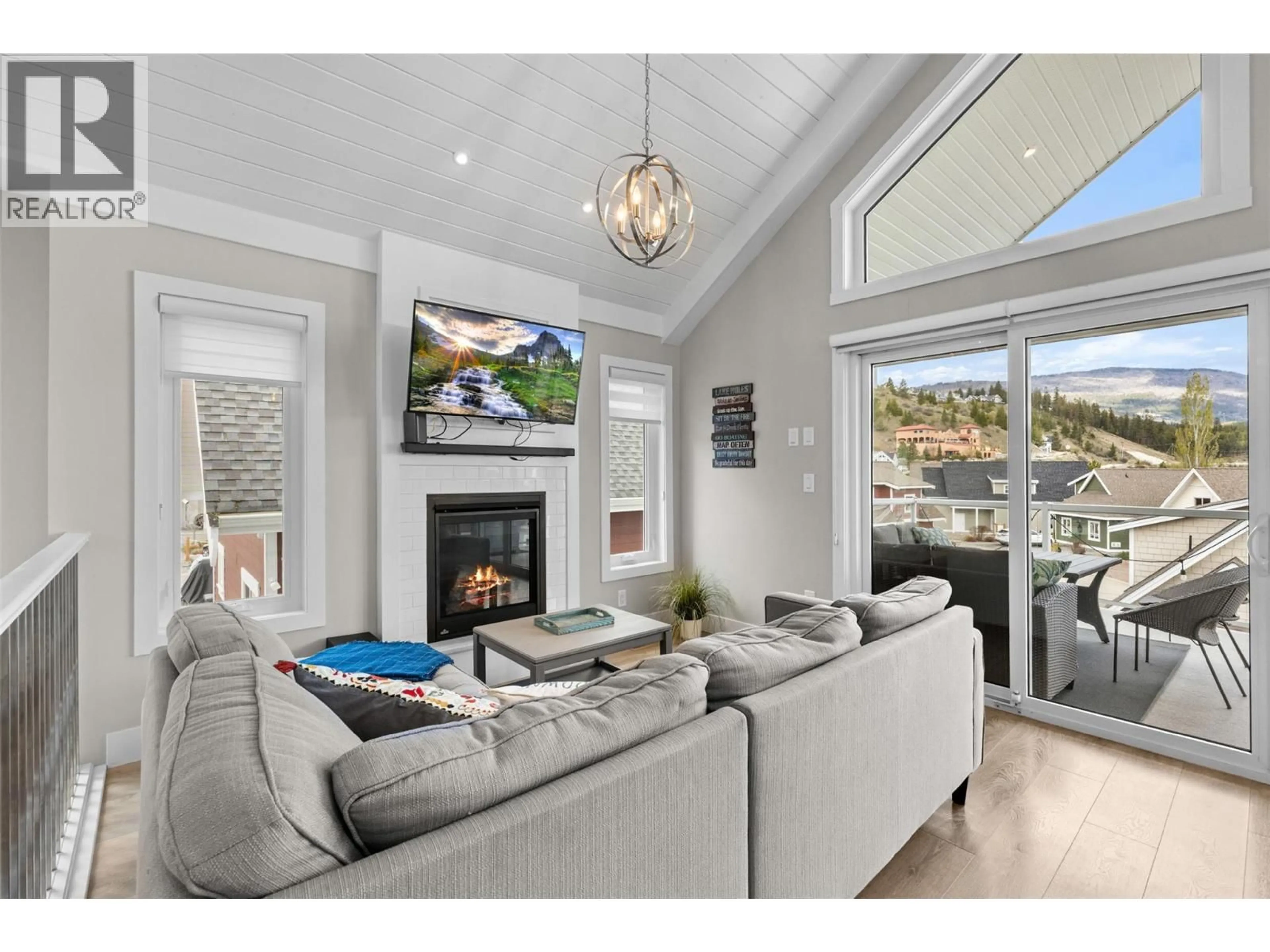 Living room with furniture, wood/laminate floor for 371 - 6727 MARBELLA LOOP, Kelowna British Columbia V1Z3R8