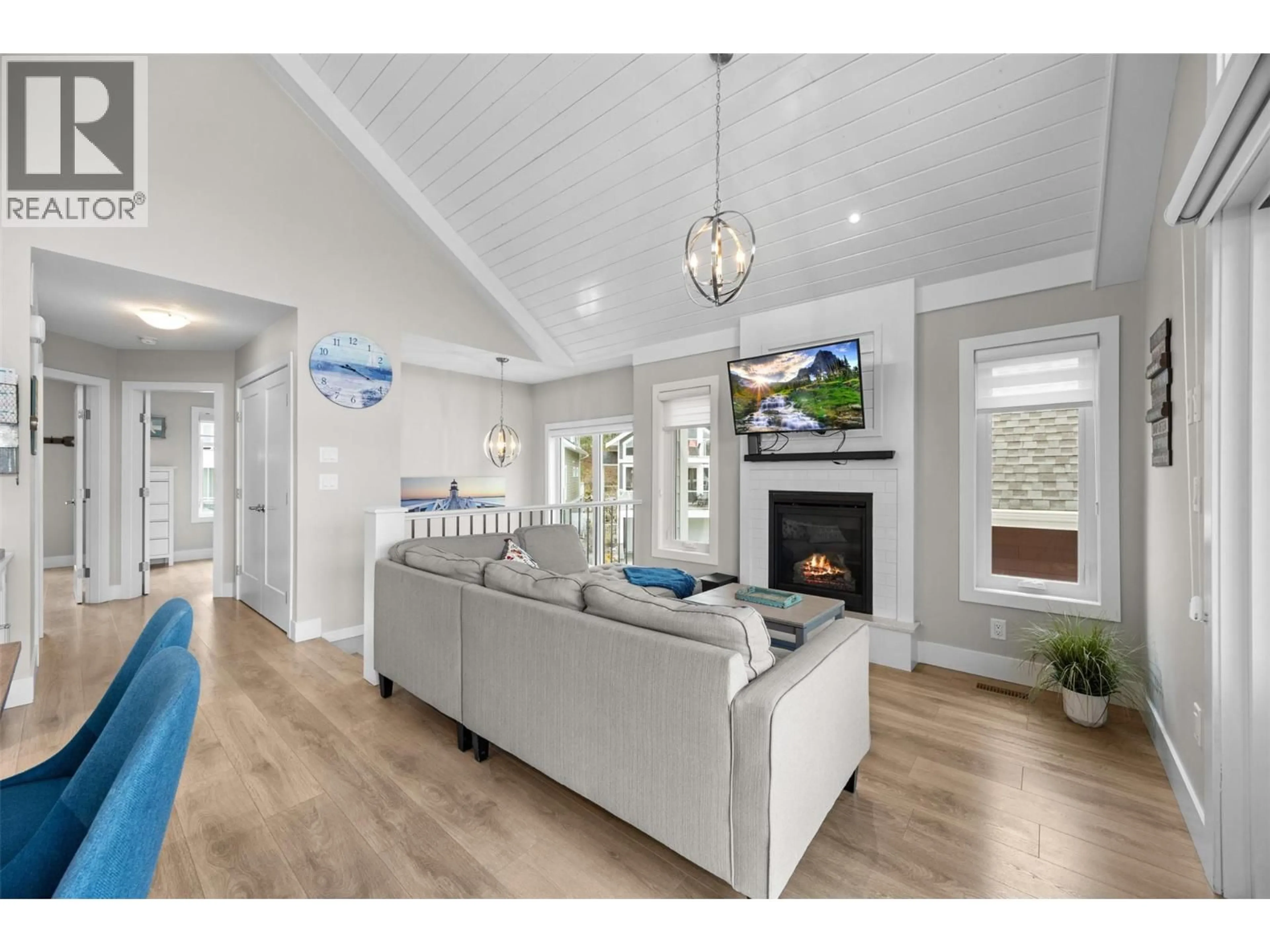 Living room with furniture, wood/laminate floor for 371 - 6727 MARBELLA LOOP, Kelowna British Columbia V1Z3R8