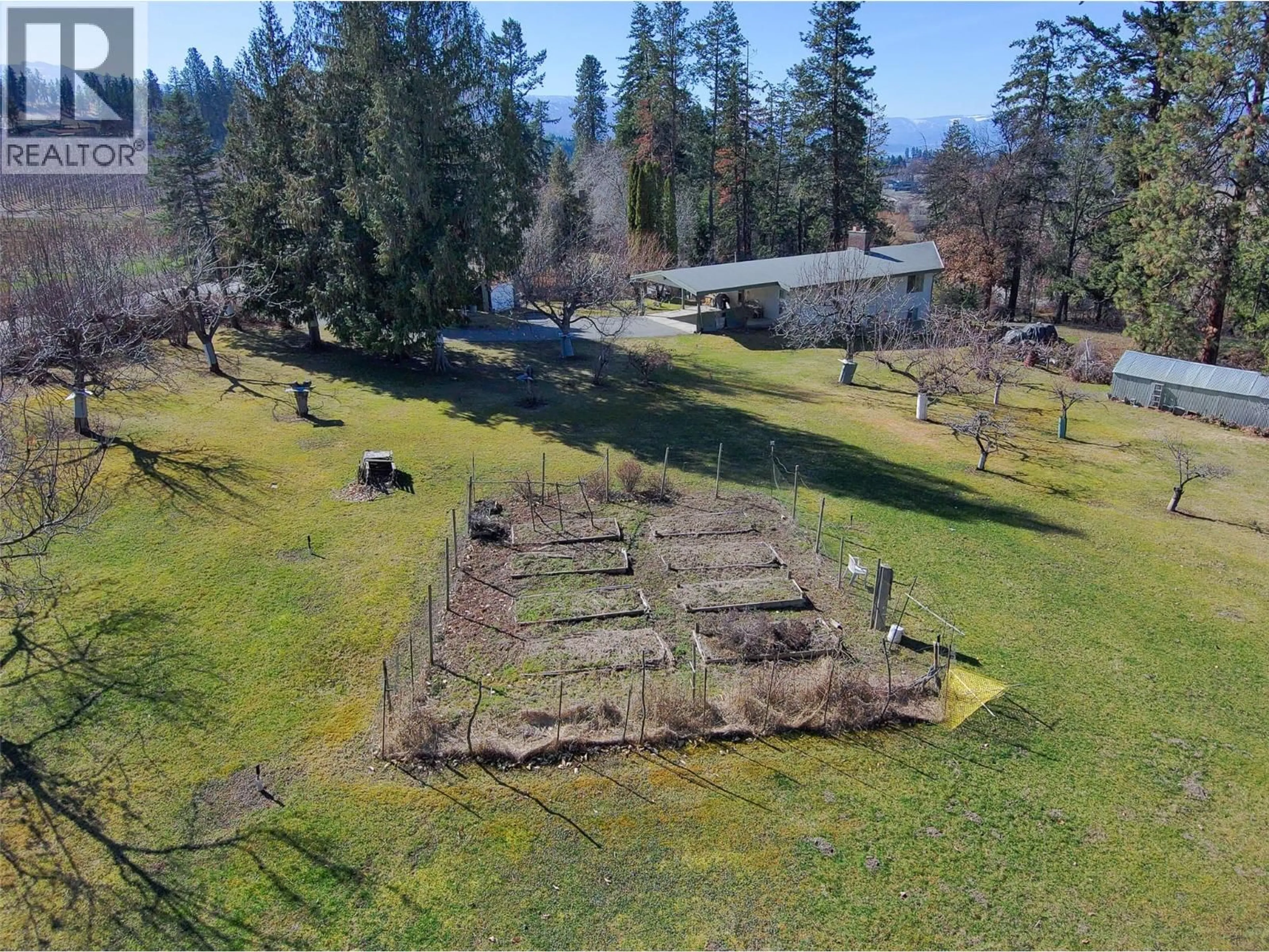 A pic from outside/outdoor area/front of a property/back of a property/a pic from drone, forest/trees view for 4150 HUGHES ROAD, Kelowna British Columbia V1W4S3