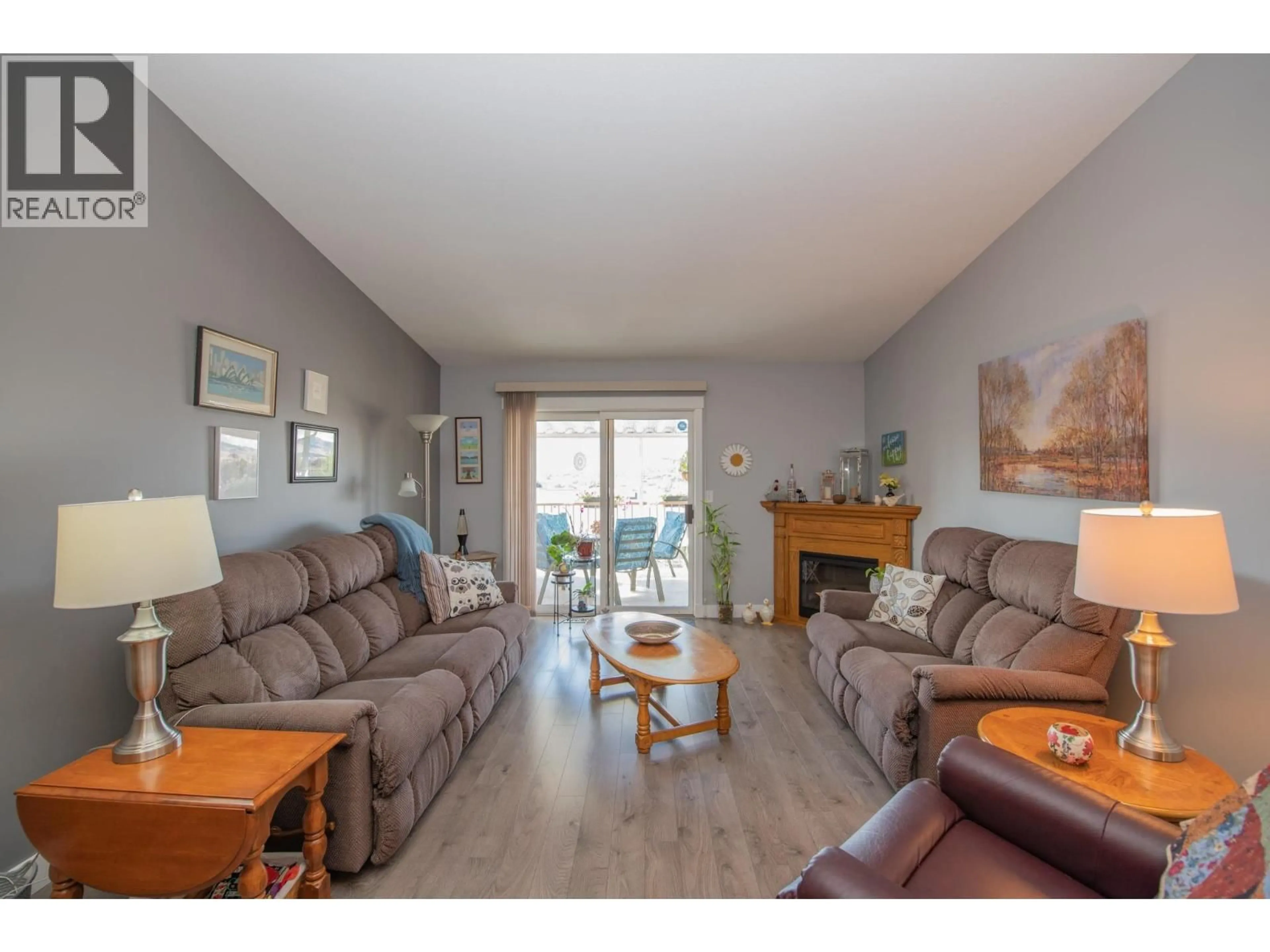 Living room with furniture, wood/laminate floor for 30 - 1001 30 AVENUE, Vernon British Columbia V1T9H8
