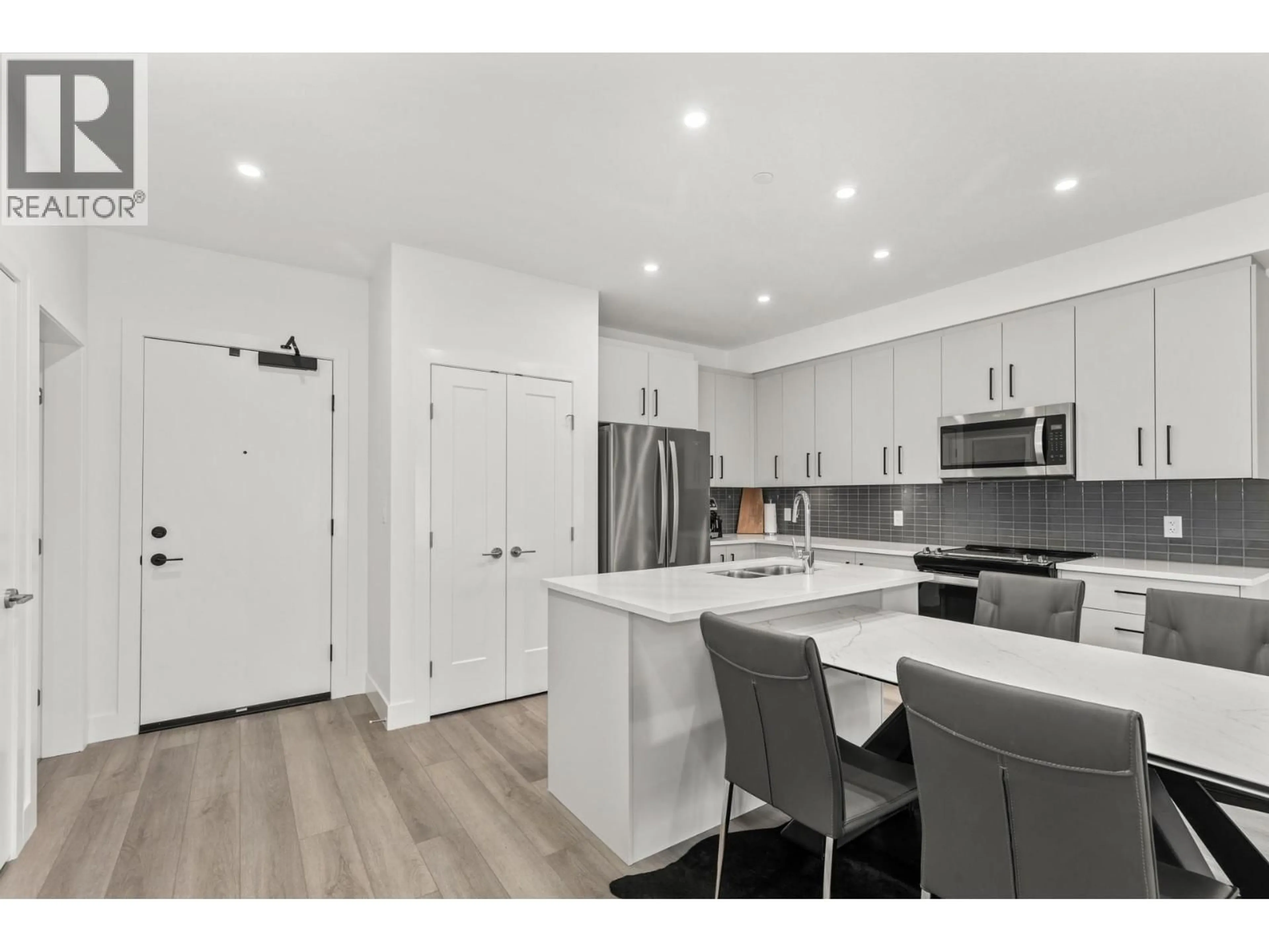 Open concept kitchen, wood/laminate floor for 302 - 3434 MCKINLEY BEACH DRIVE, Kelowna British Columbia V1V2R1