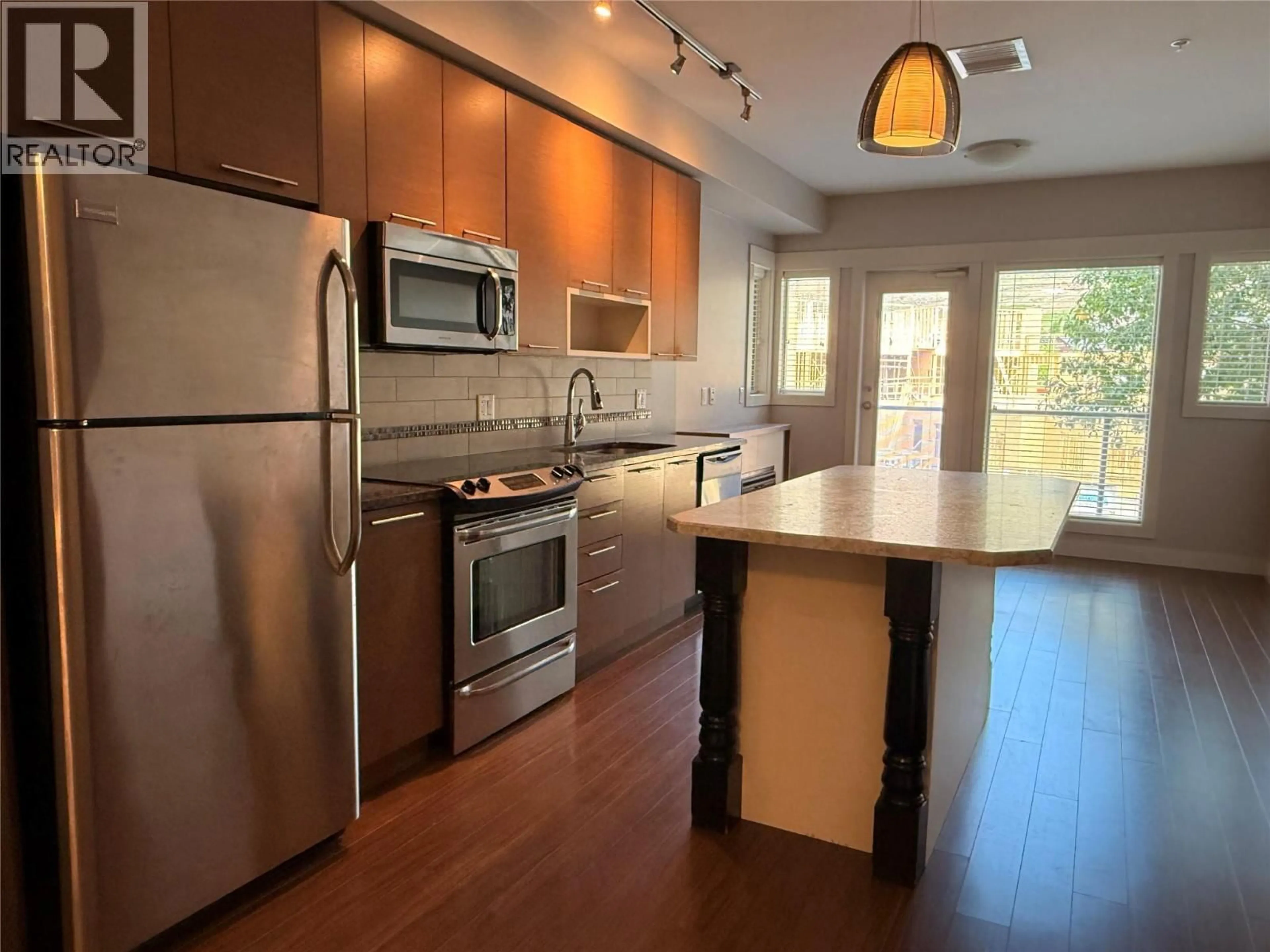 Open concept kitchen, wood/laminate floor for 3202 - 1040 TALASA COURT, Kamloops British Columbia V2H0C4
