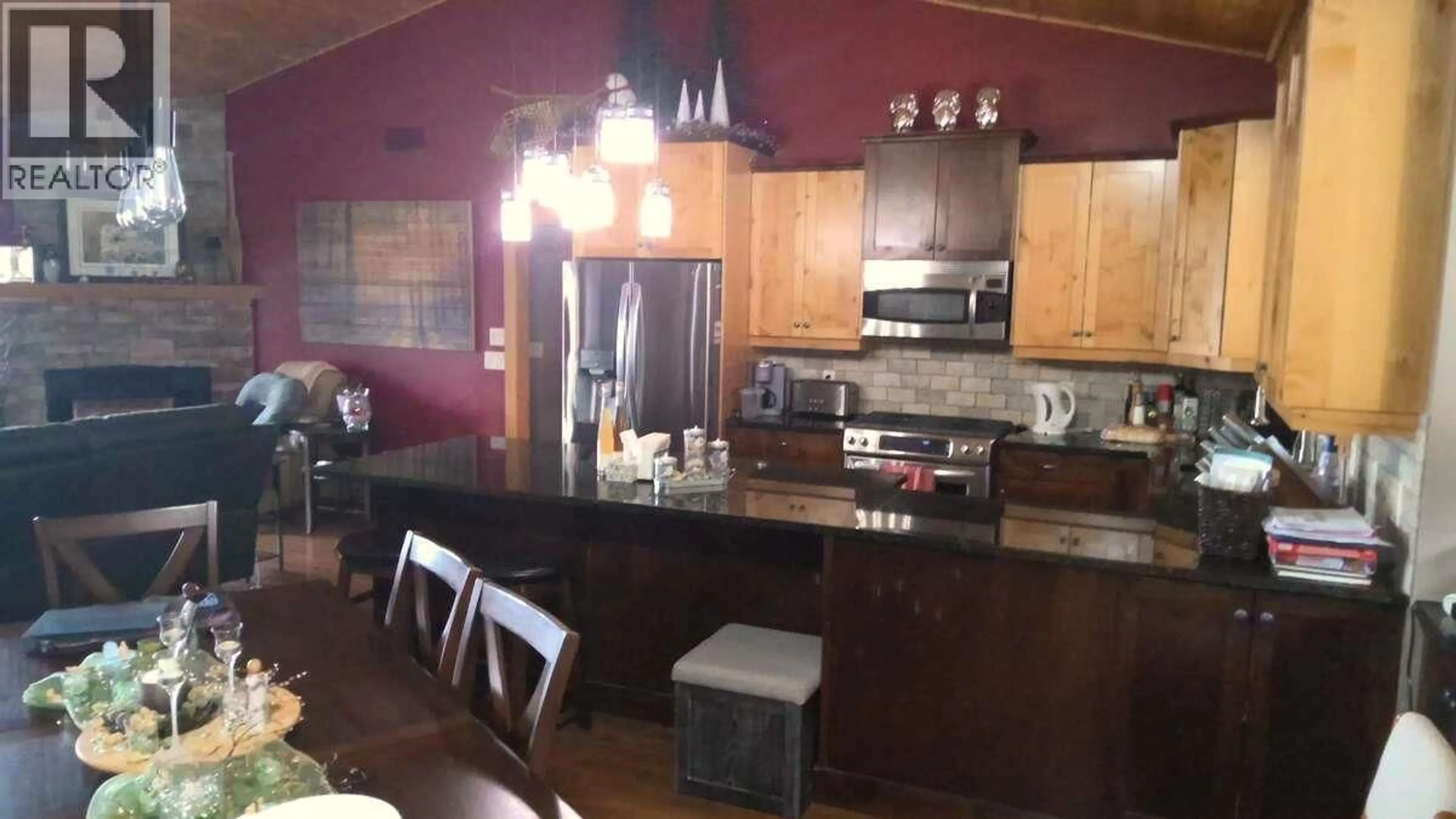 Open concept kitchen, wood/laminate floor for 7080 SUN VALLEY ROAD, Kelowna British Columbia V1P1H4