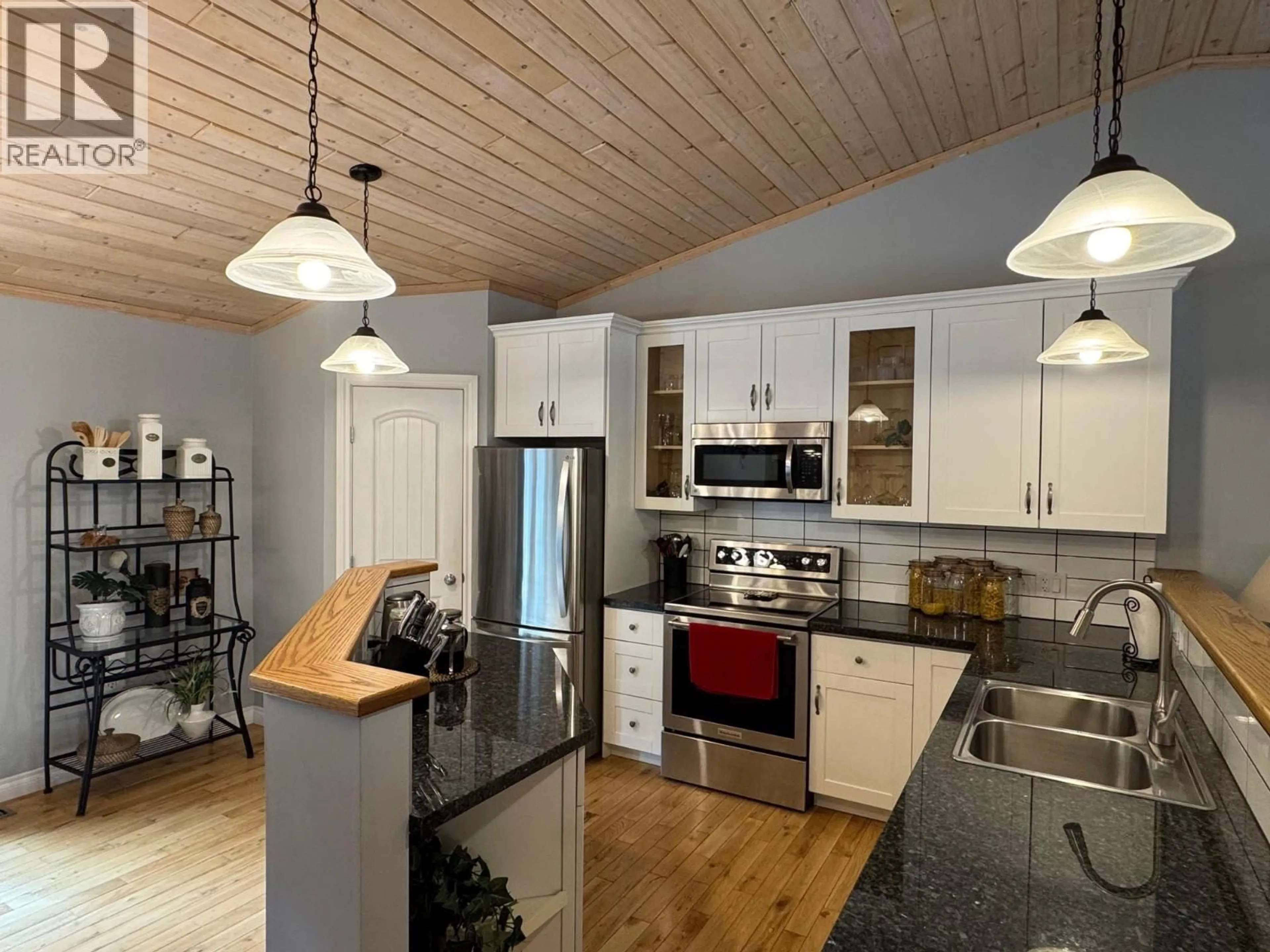 Open concept kitchen, wood/laminate floor for 5 COTTONWOOD ROAD, Beaverdell British Columbia V0H1A0