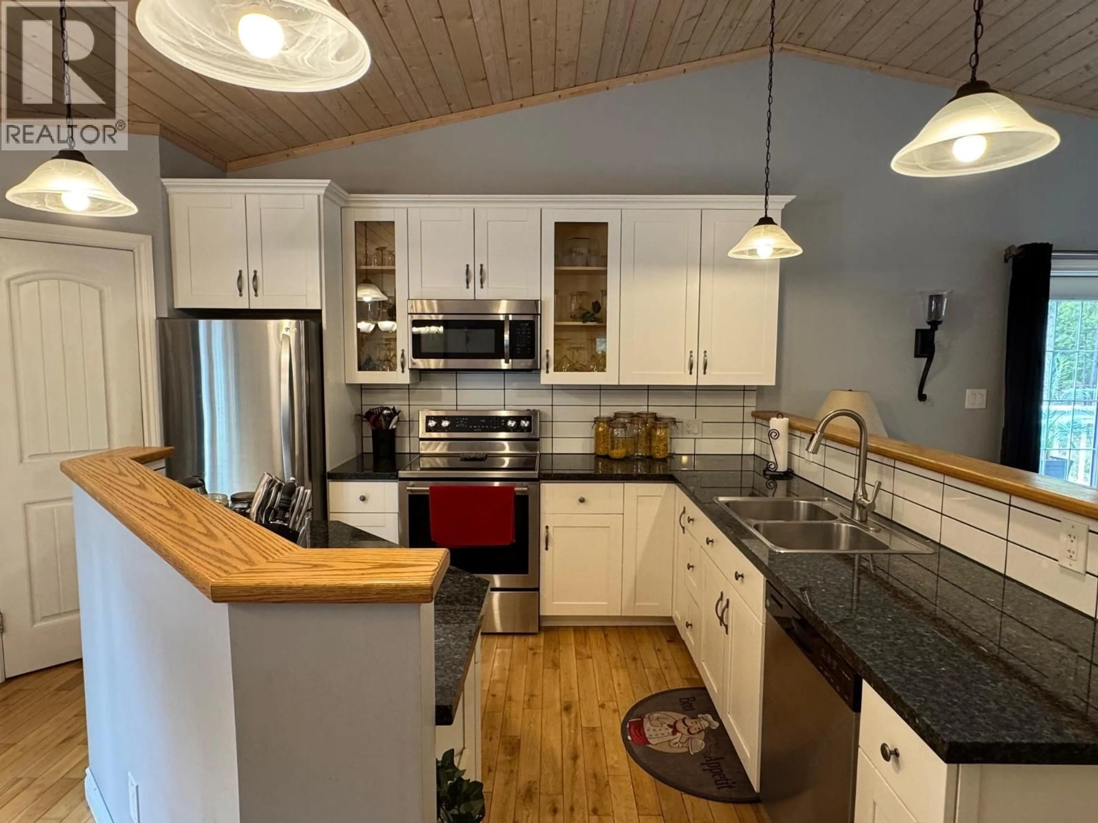 Open concept kitchen, wood/laminate floor for 5 COTTONWOOD ROAD, Beaverdell British Columbia V0H1A0