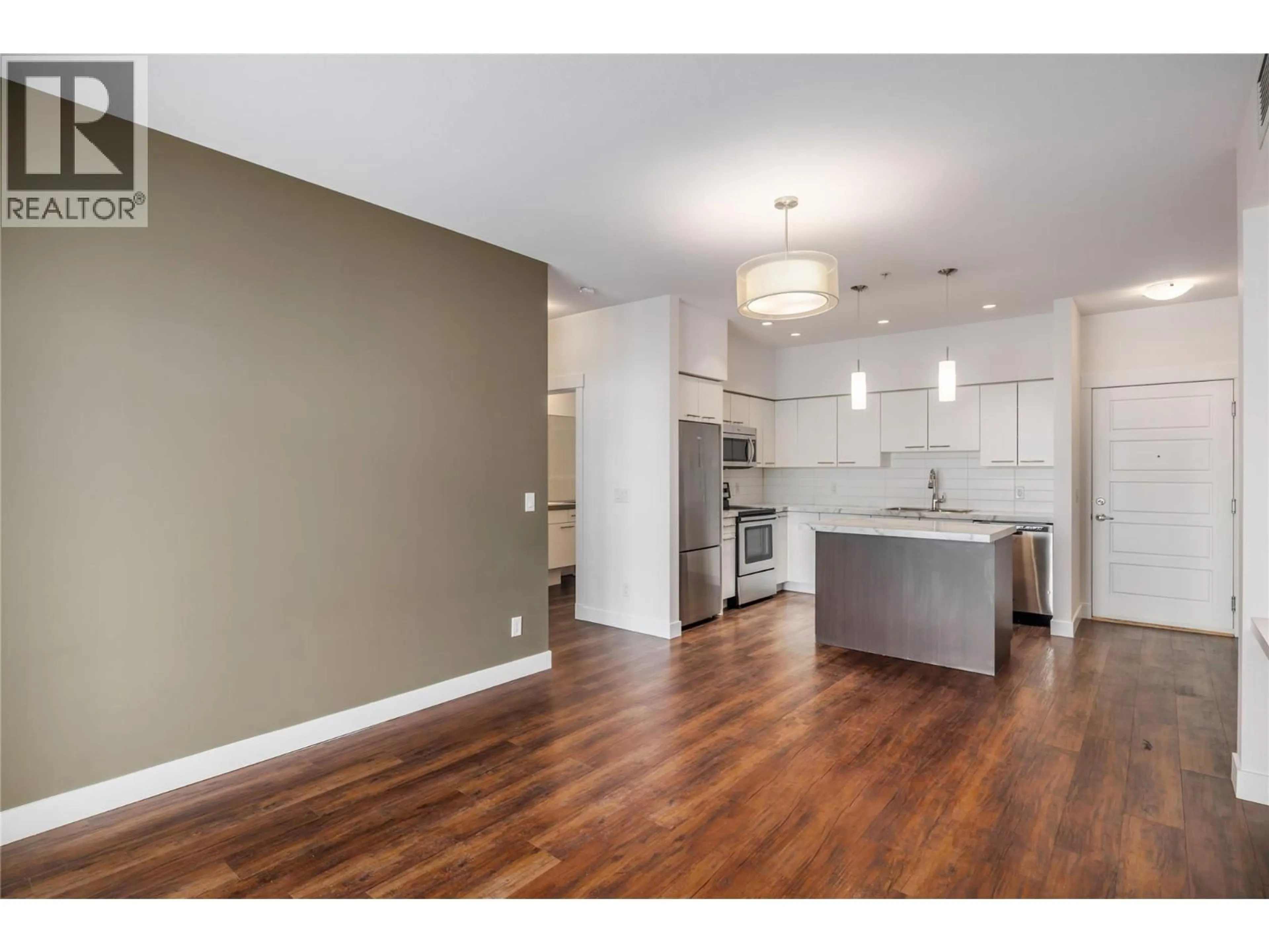 Open concept kitchen, wood/laminate floor for 214 - 975 ACADEMY WAY, Kelowna British Columbia V1V3C8