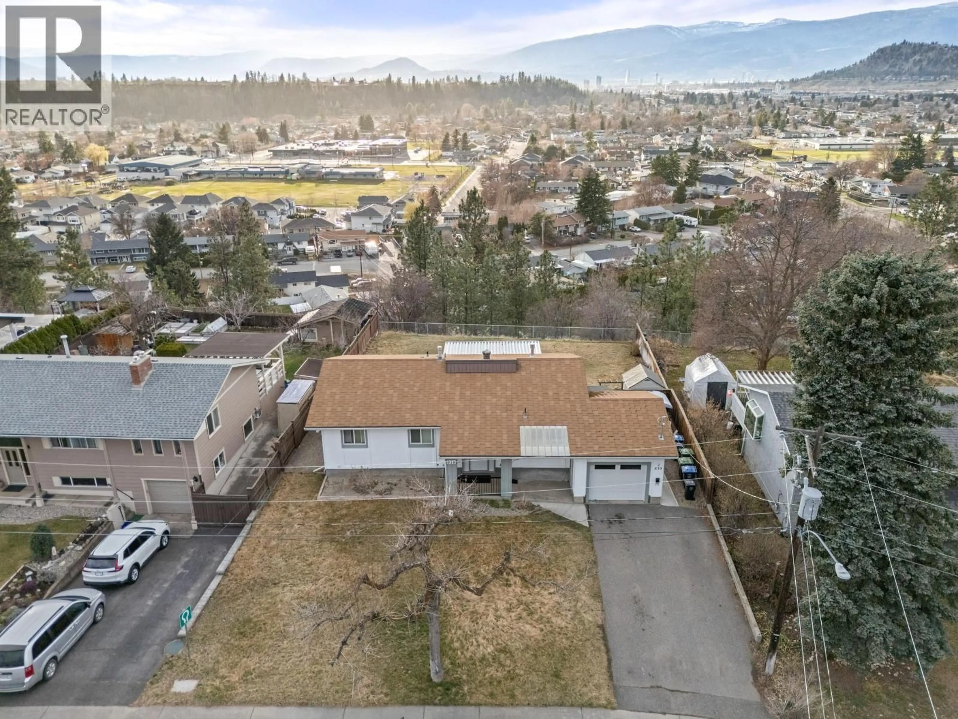 A pic from outside/outdoor area/front of a property/back of a property/a pic from drone, mountain view for 870 DOUGALL ROAD SOUTH, Kelowna British Columbia V1X3J8