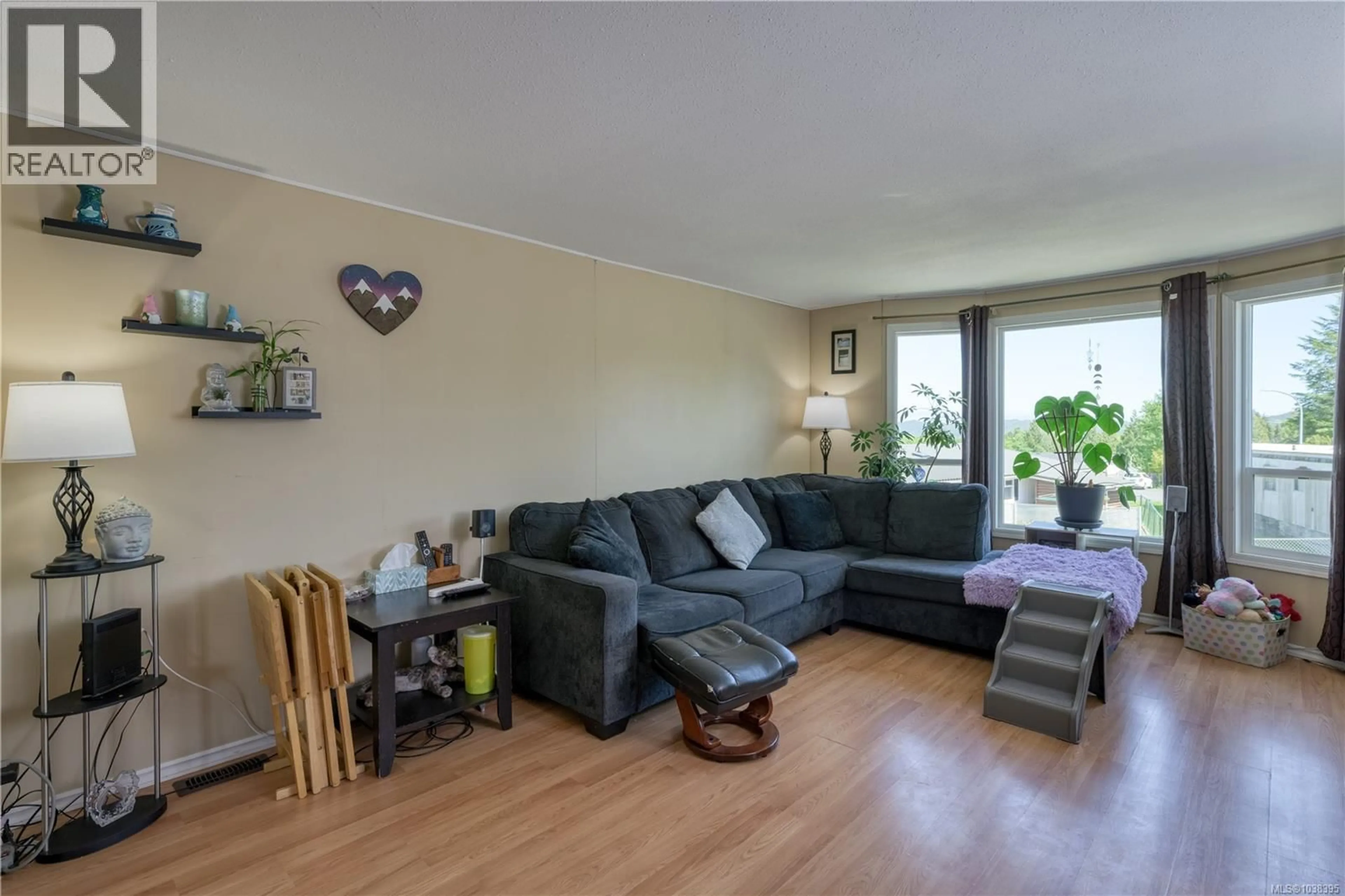 Living room with furniture, wood/laminate floor for 7296 TEAKERNE DRIVE, Port Hardy British Columbia V0N2P0