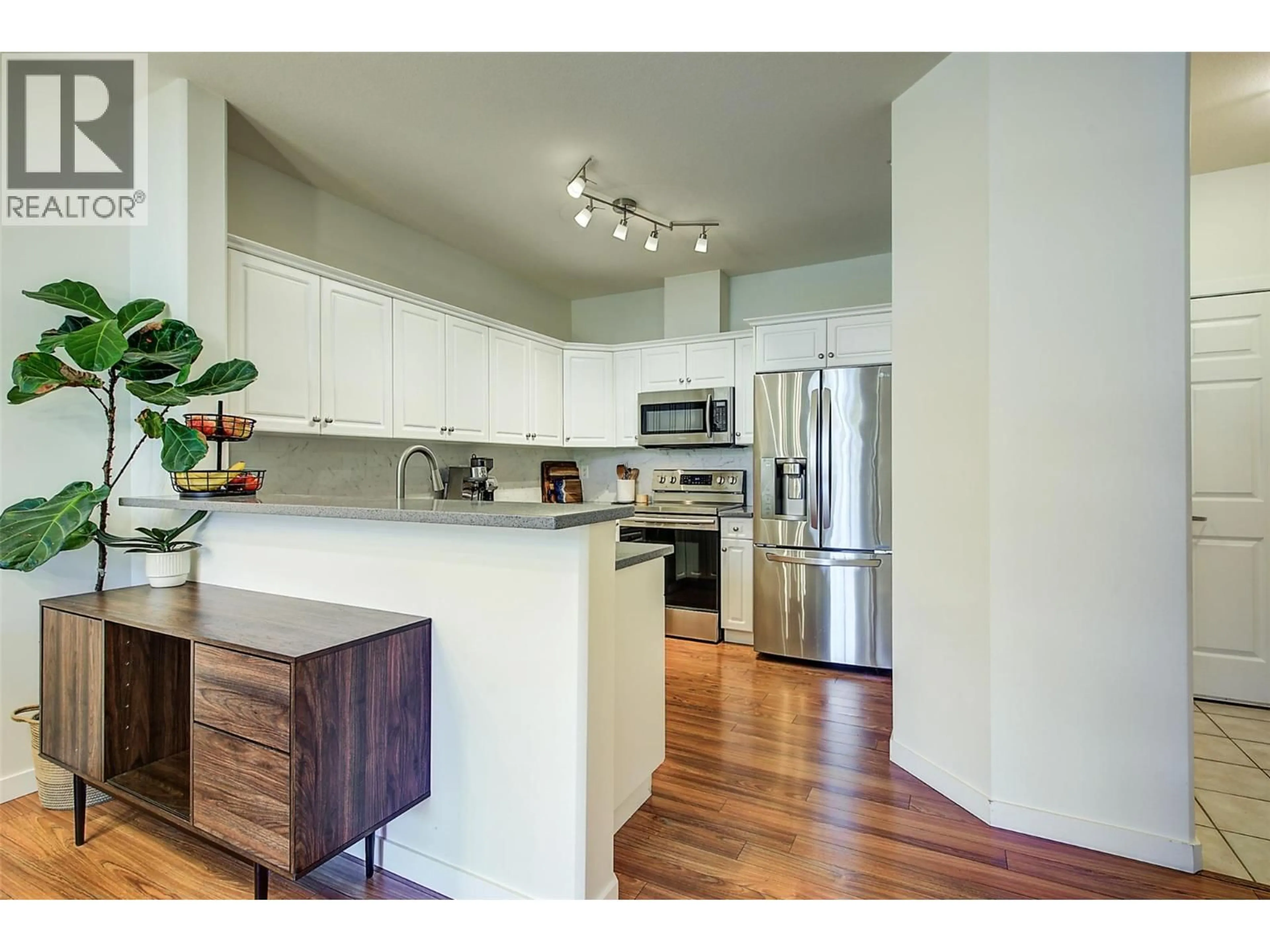 Open concept kitchen, wood/laminate floor for 411 - 680 LEQUIME ROAD, Kelowna British Columbia V1W1A4