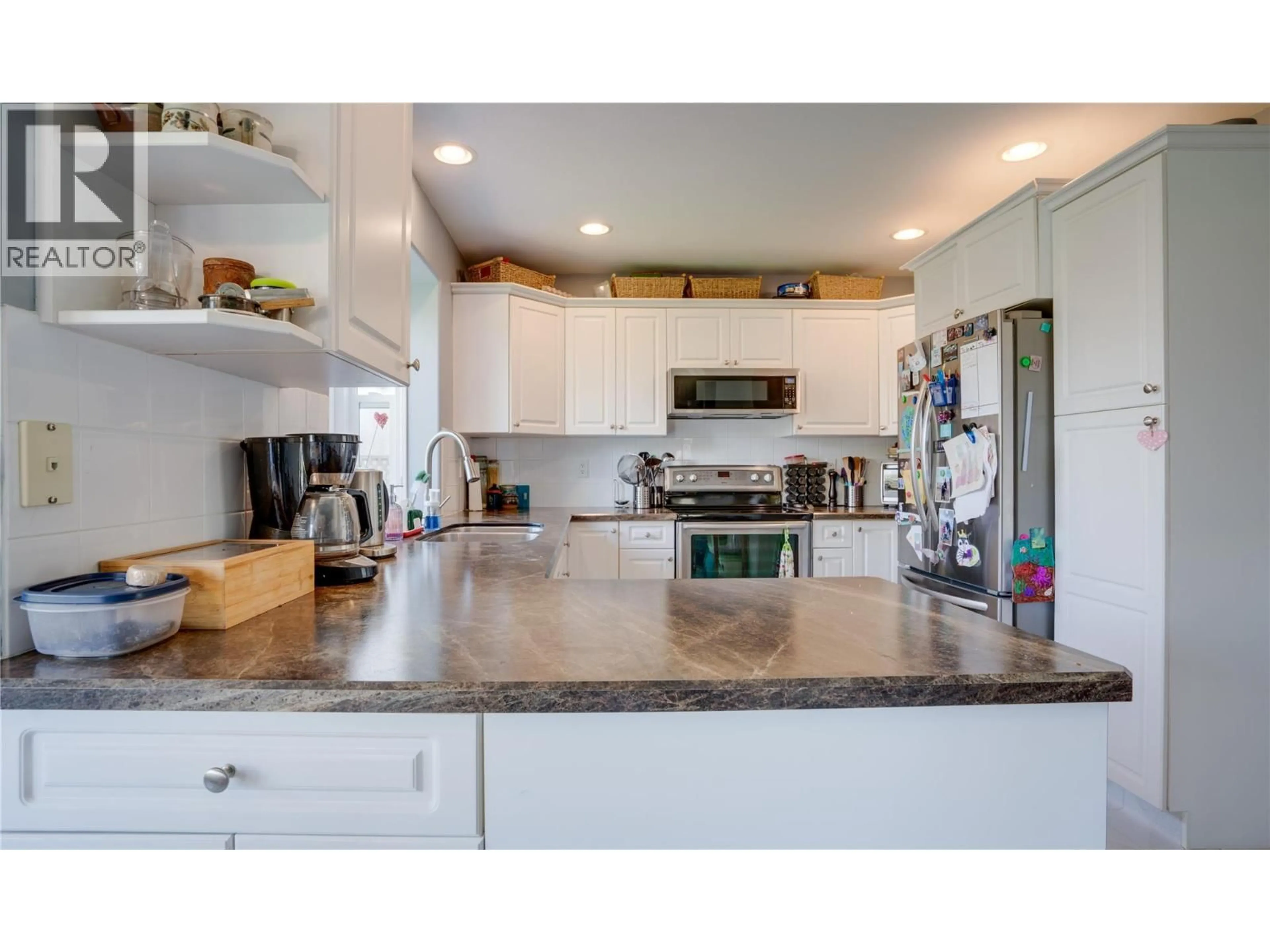 Open concept kitchen, ceramic/tile floor for 709 CAVALIER COURT, Vernon British Columbia V1T9M6