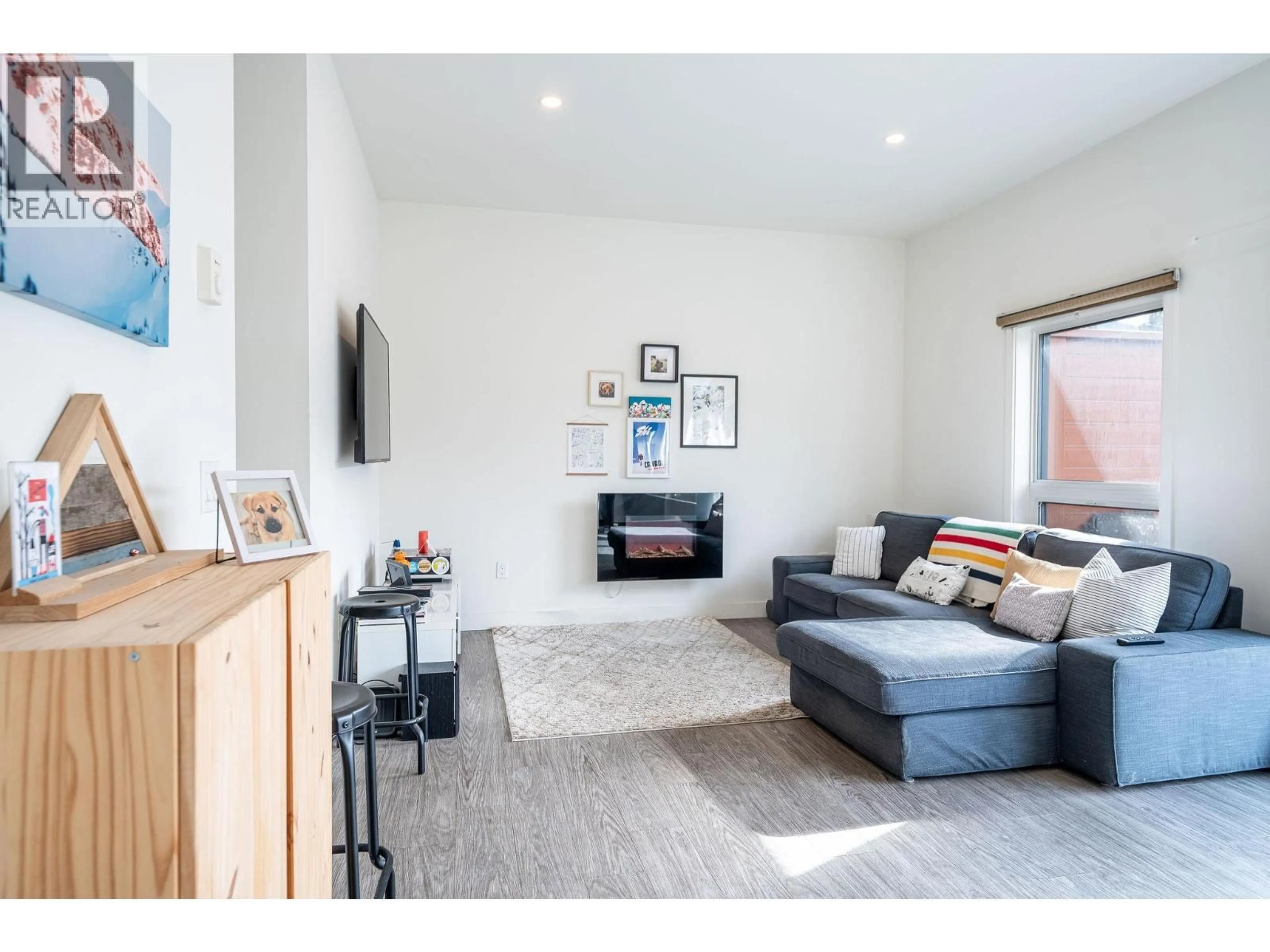 Living room with furniture, wood/laminate floor for 1204 - 1901 NELS NELSON CRESCENT, Revelstoke British Columbia V0E2S3