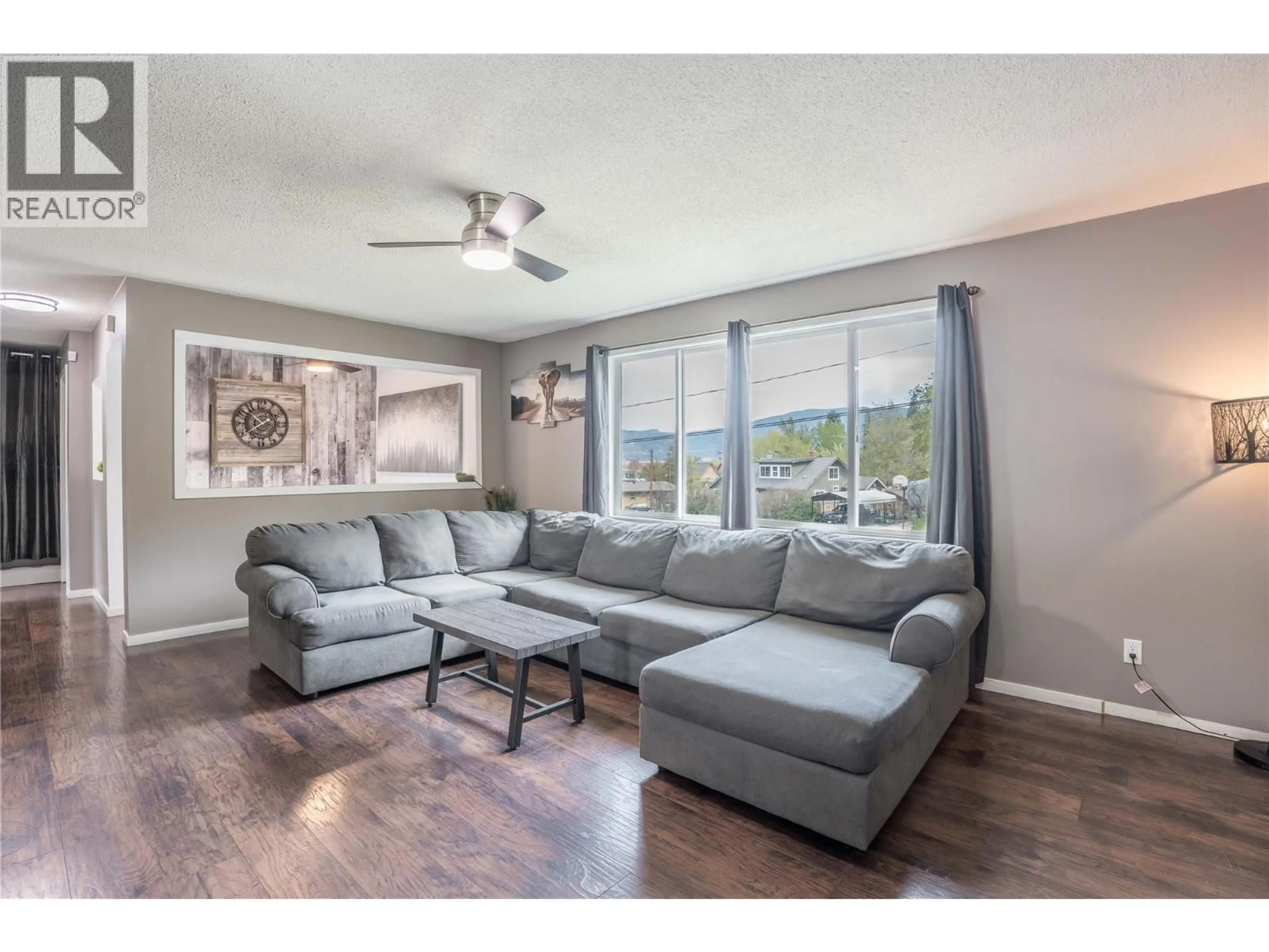 Living room with furniture, wood/laminate floor for 12408 CAMPBELL CRESCENT, Summerland British Columbia V0H1Z0