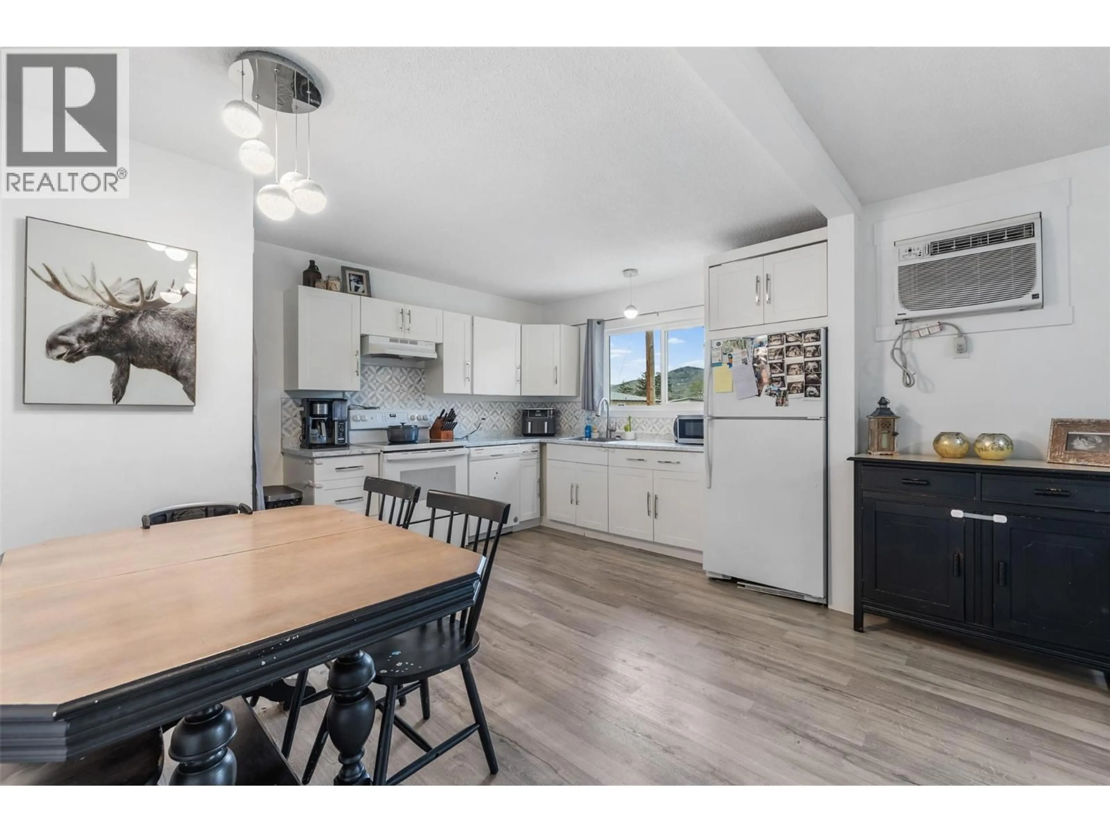 Open concept kitchen, wood/laminate floor for 1801 42A STREET, Vernon British Columbia V1T7H3