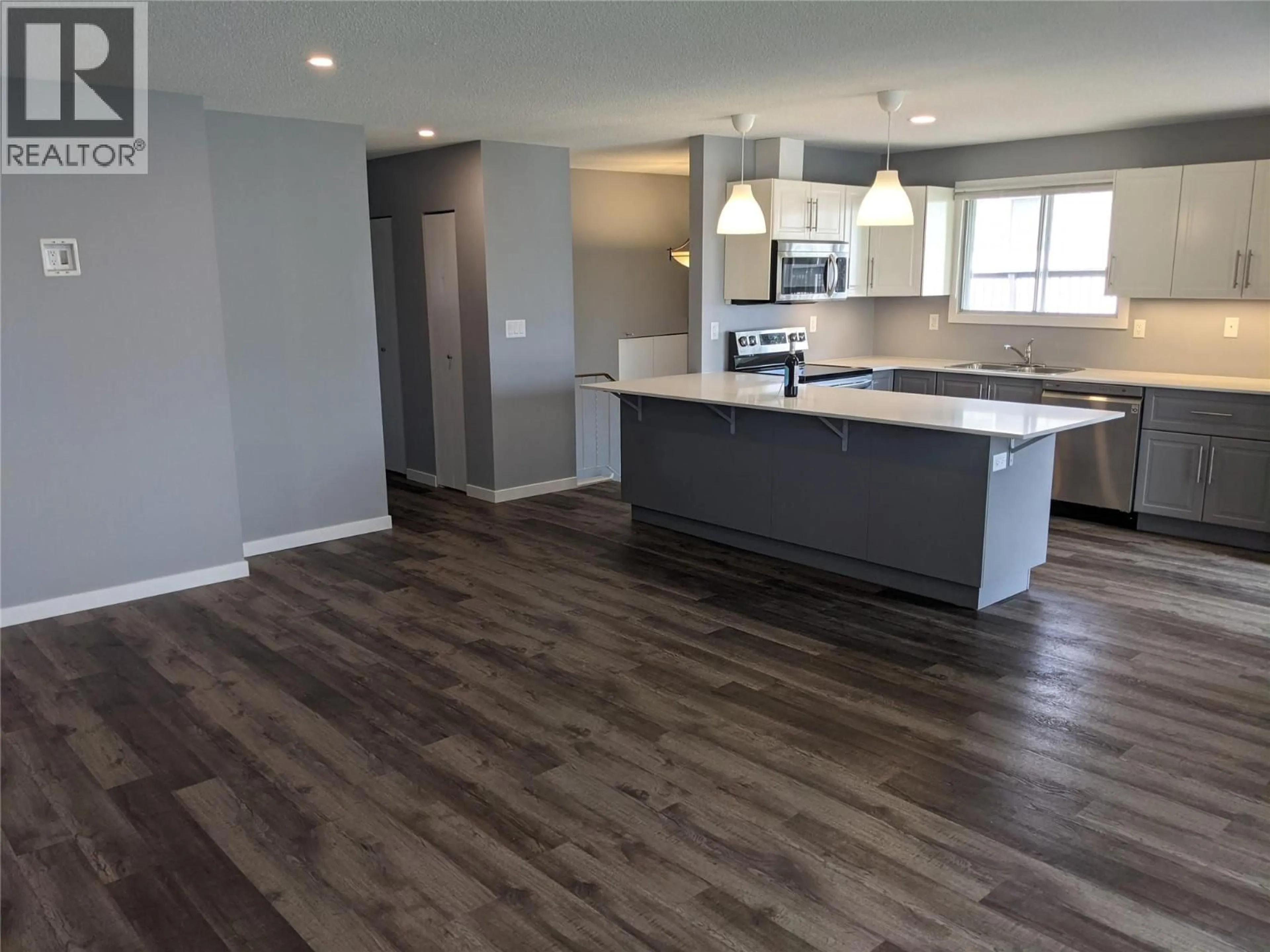 Open concept kitchen, wood/laminate floor for 3170/3172 WAWN CRESCENT, Kamloops British Columbia V2B7J6