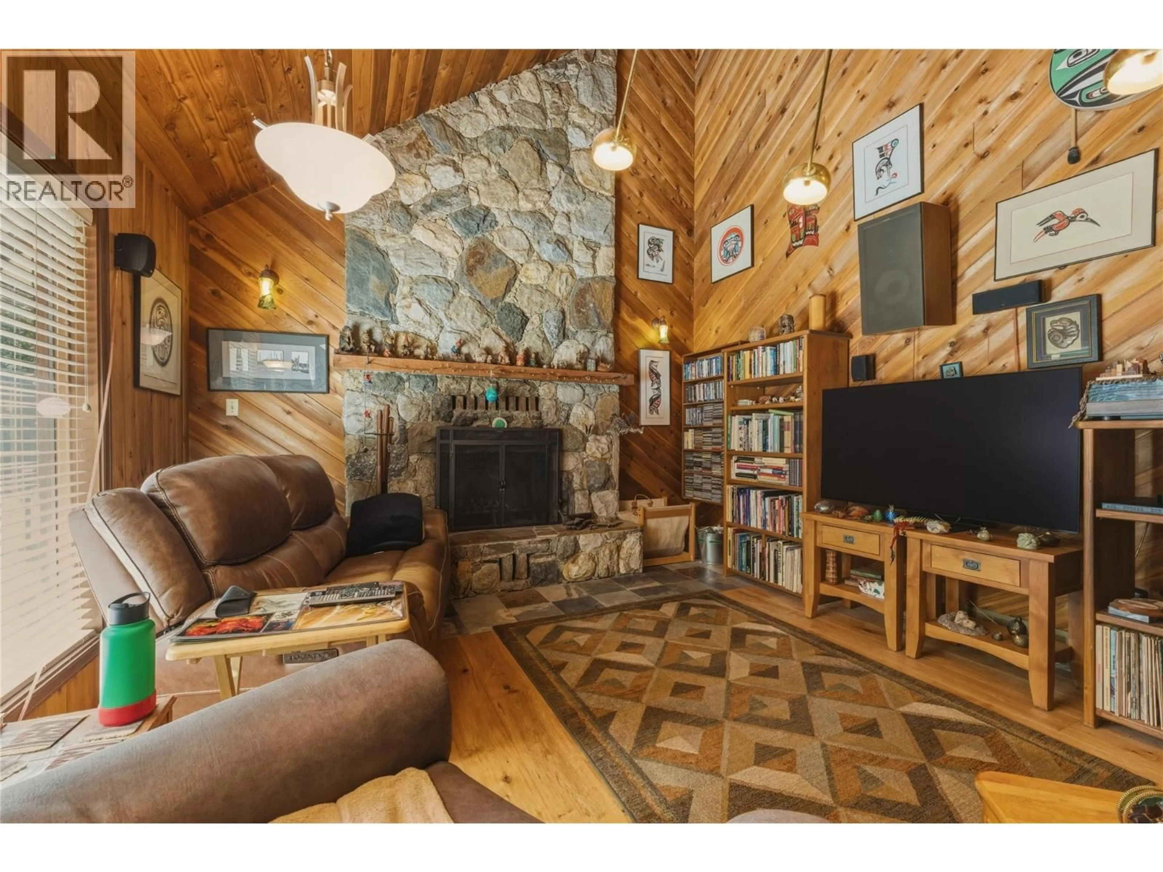 Living room with furniture, wood/laminate floor for 8257 ROGERS ROAD, Vernon British Columbia V1B3M7