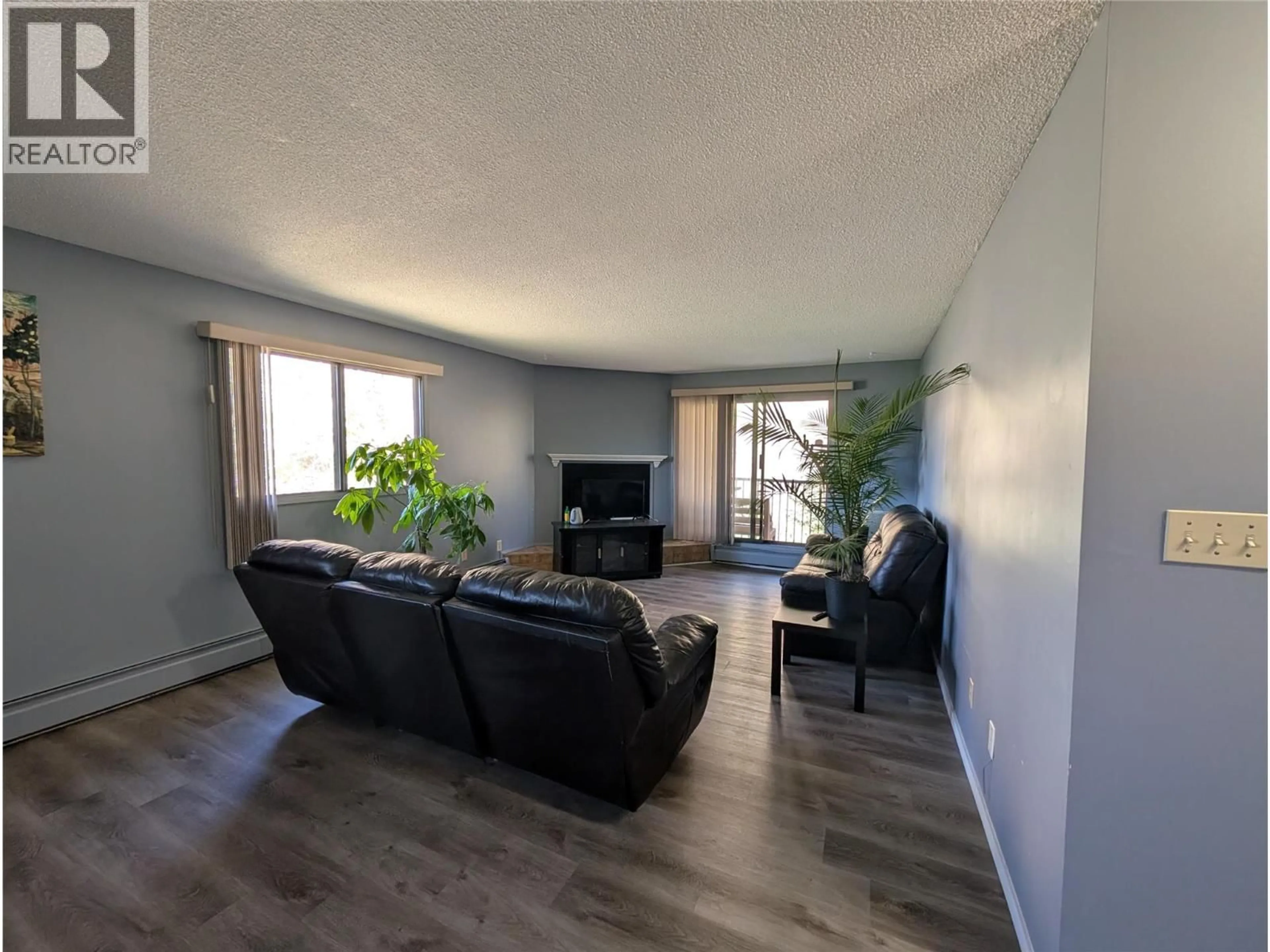 Living room with furniture, wood/laminate floor for 414 - 3901 32 AVENUE, Vernon British Columbia V1T8M3