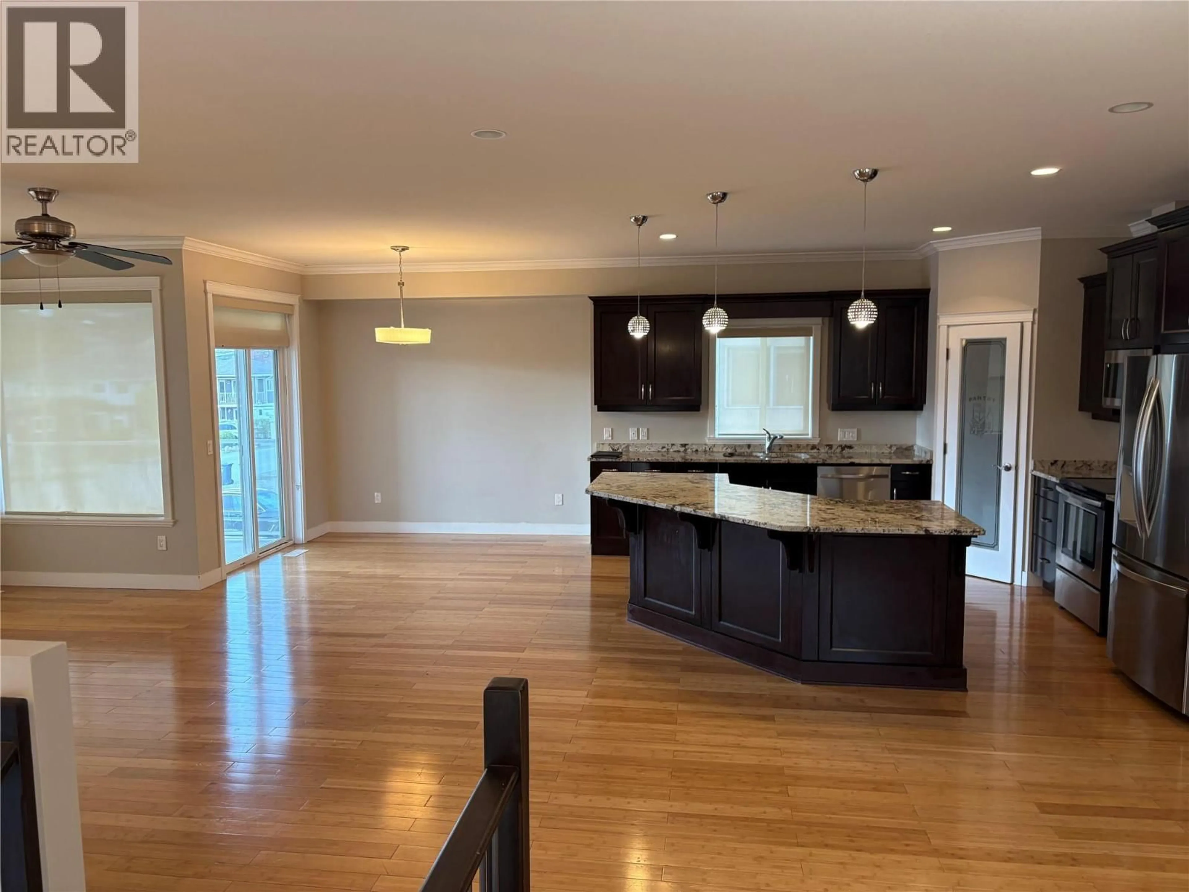 Open concept kitchen, wood/laminate floor for 435 TAYLOR ROAD, Kelowna British Columbia V1X4G3