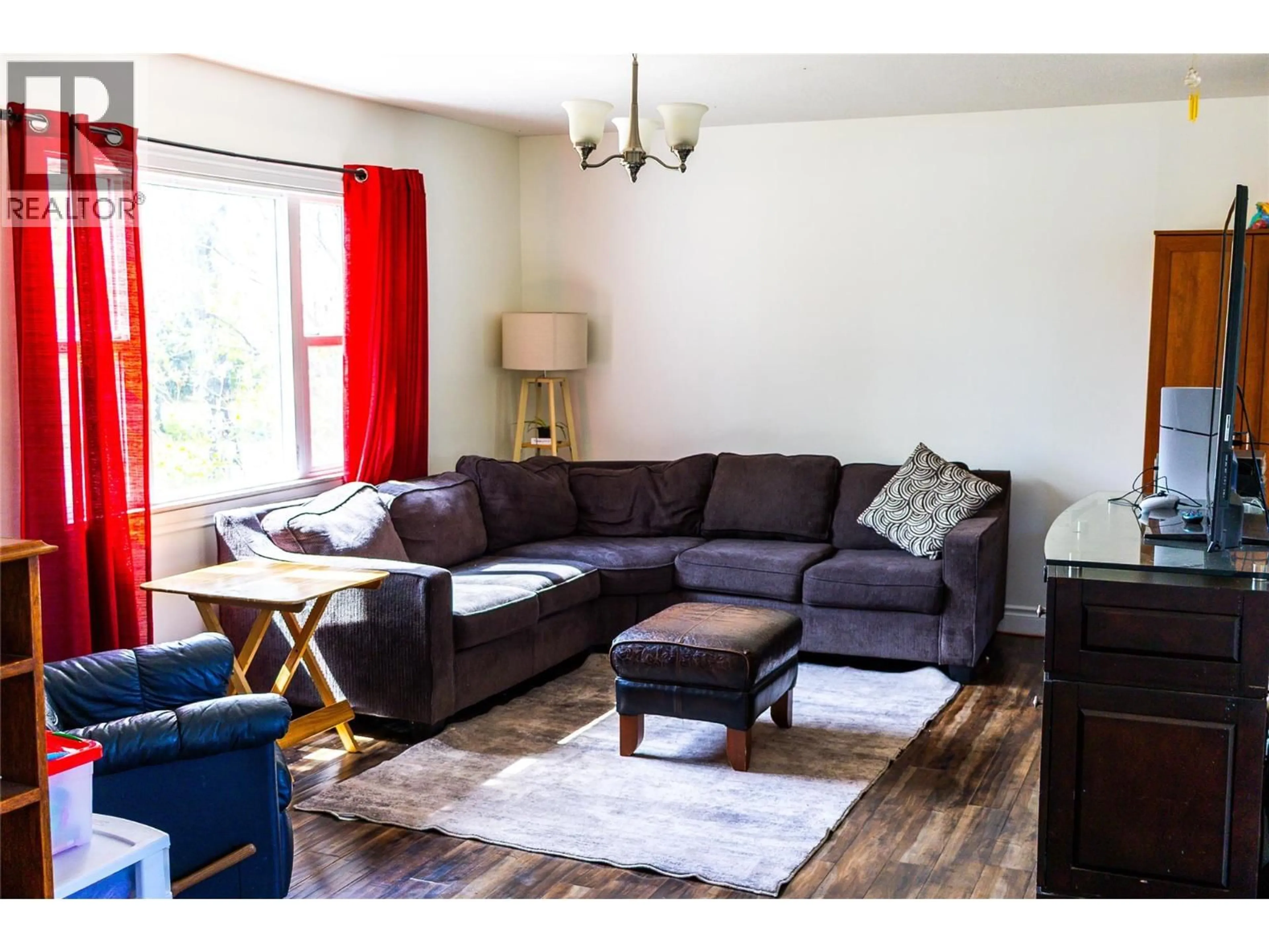 Living room with furniture, wood/laminate floor for 1924 90 AVENUE, Dawson Creek British Columbia V1G1A6