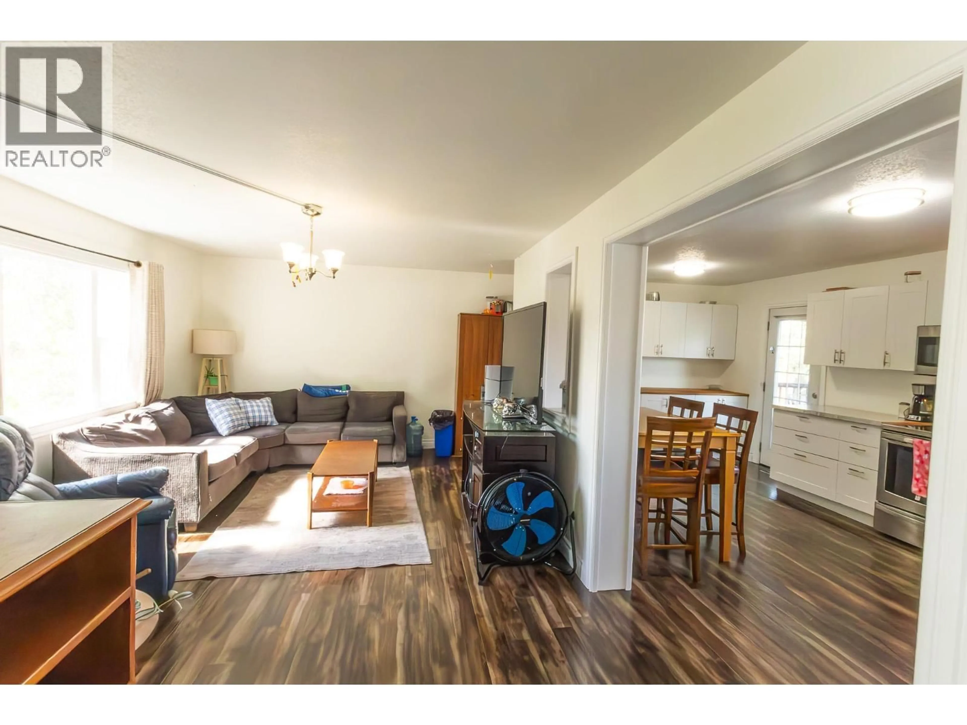 Living room with furniture, wood/laminate floor for 1924 90 AVENUE, Dawson Creek British Columbia V1G1A6