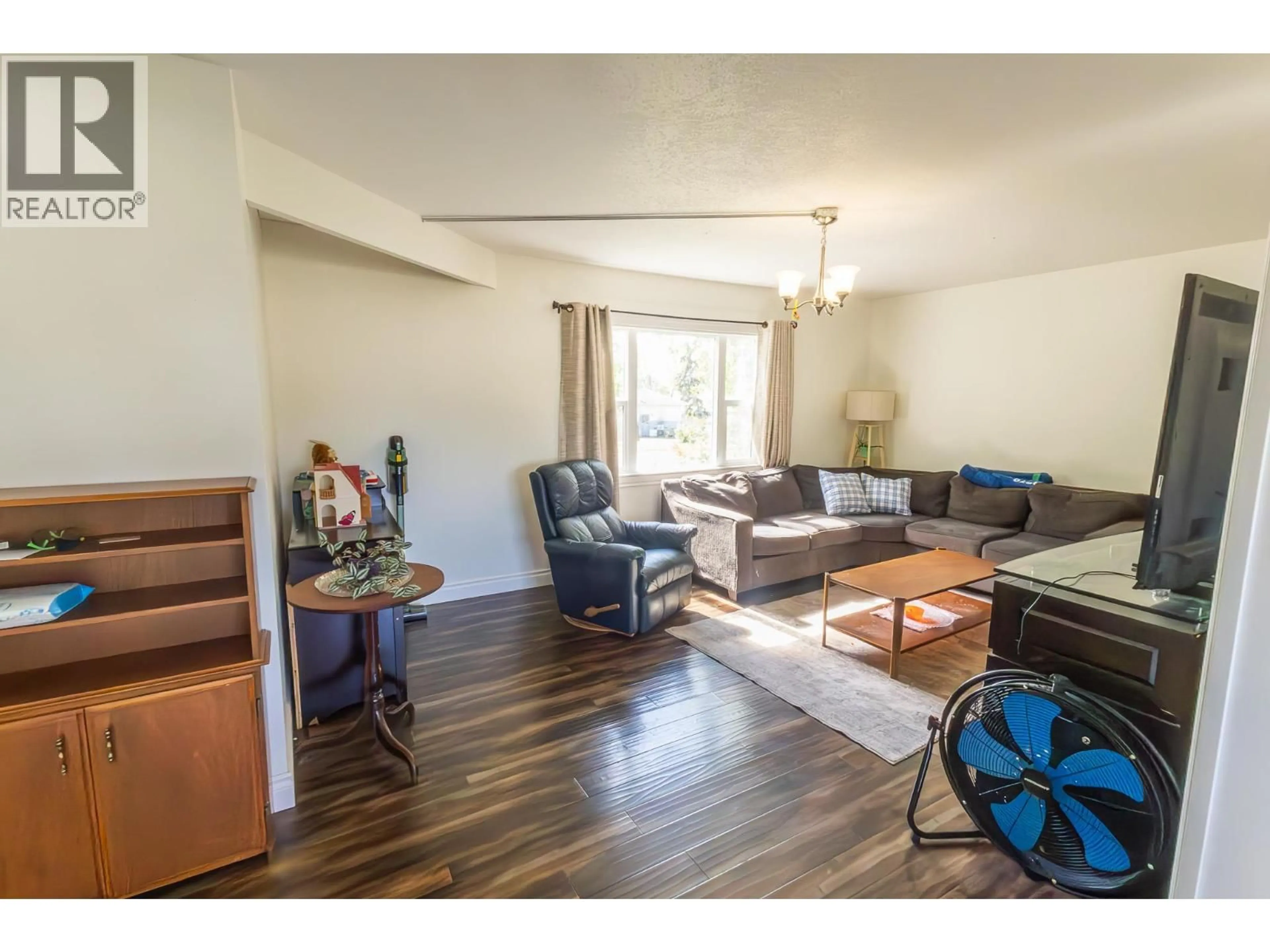 Living room with furniture, wood/laminate floor for 1924 90 AVENUE, Dawson Creek British Columbia V1G1A6