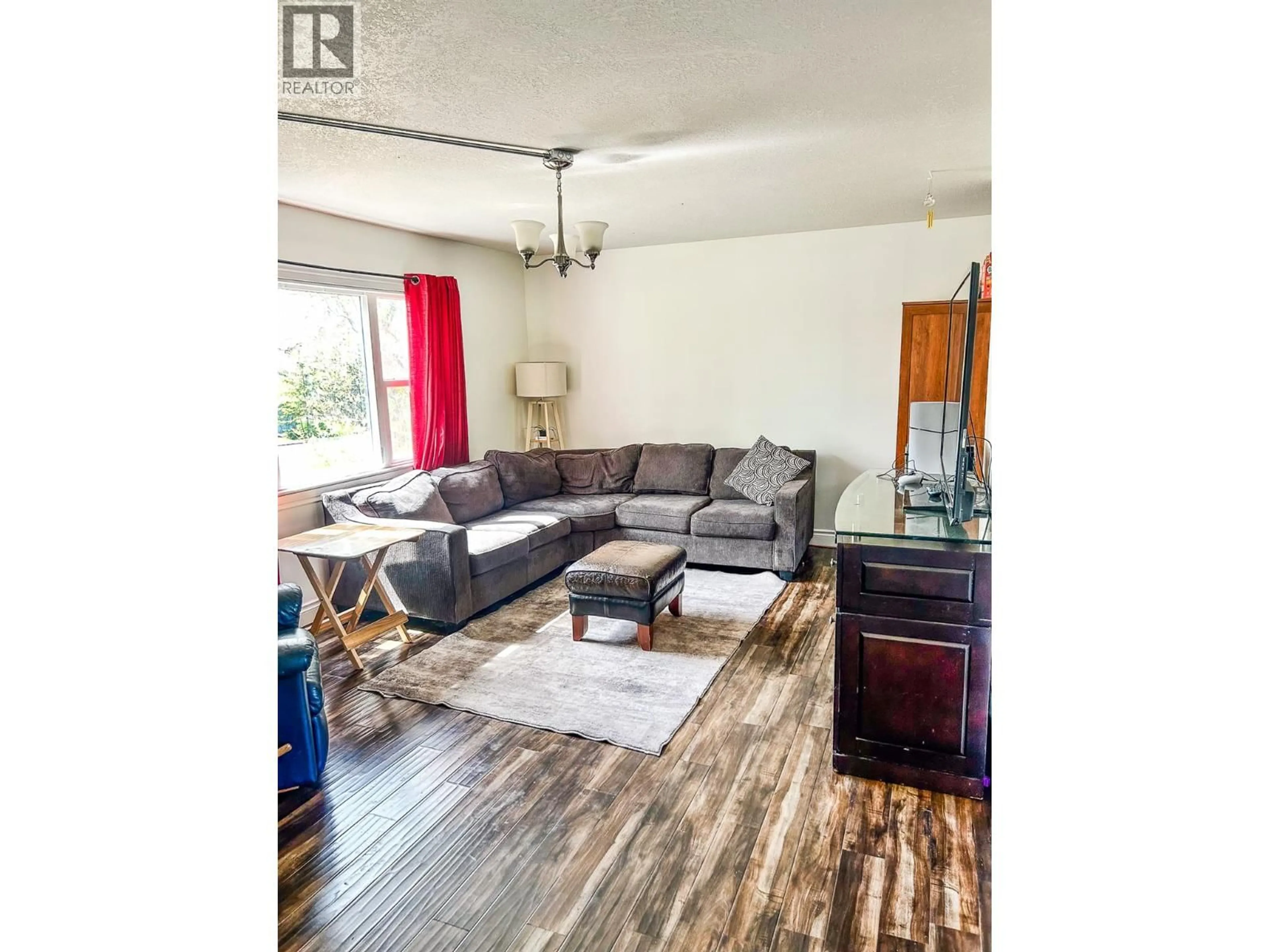 Living room with furniture, wood/laminate floor for 1924 90 AVENUE, Dawson Creek British Columbia V1G1A6