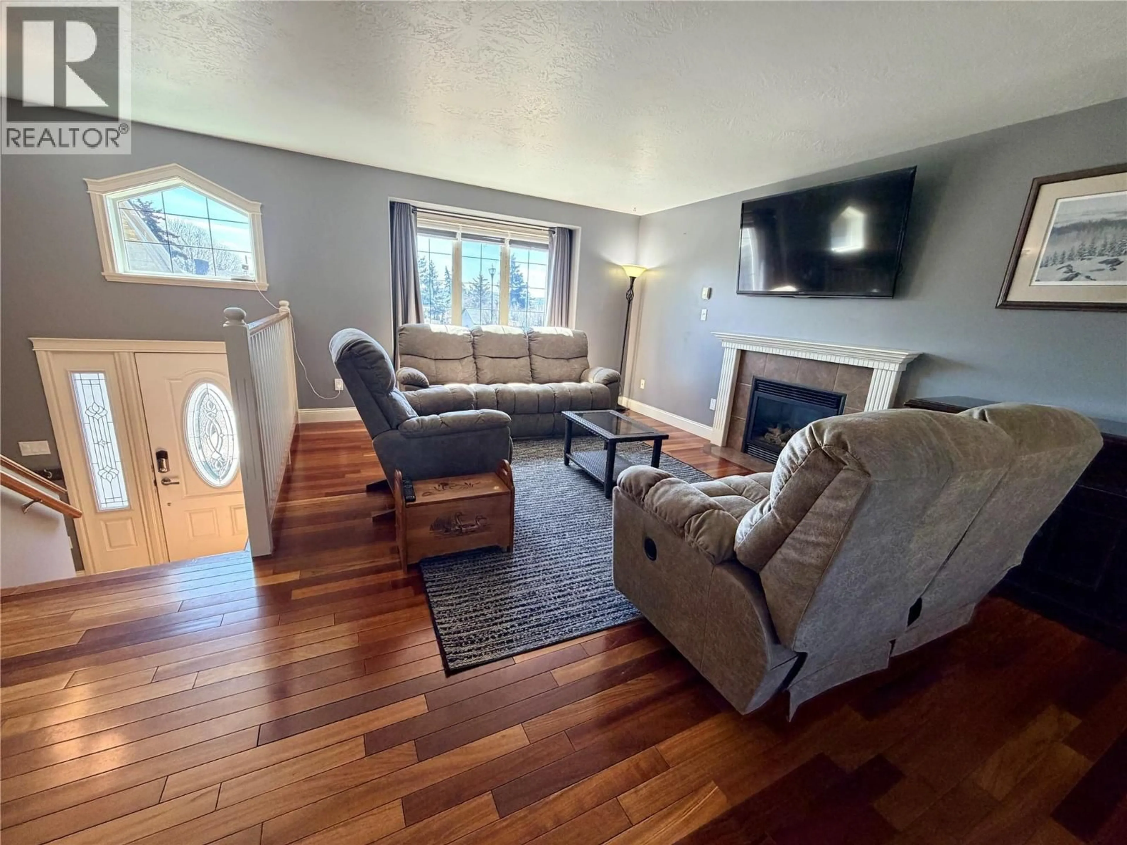 Living room with furniture, wood/laminate floor for 904 90 AVENUE, Dawson Creek British Columbia V1G5B5