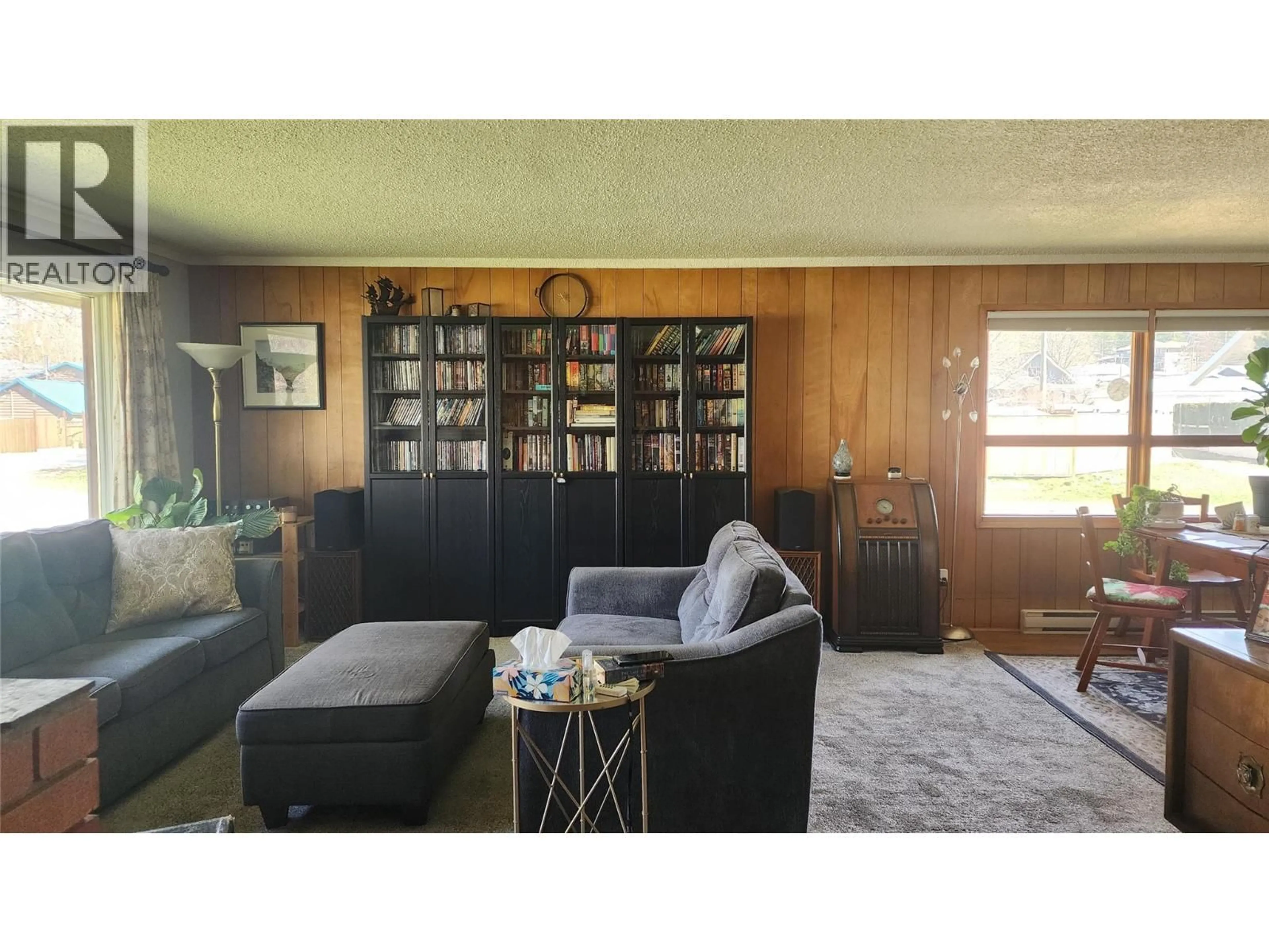 Living room with furniture, wood/laminate floor for 119 2ND AVENUE NORTHWEST, Nakusp British Columbia V0G1R0