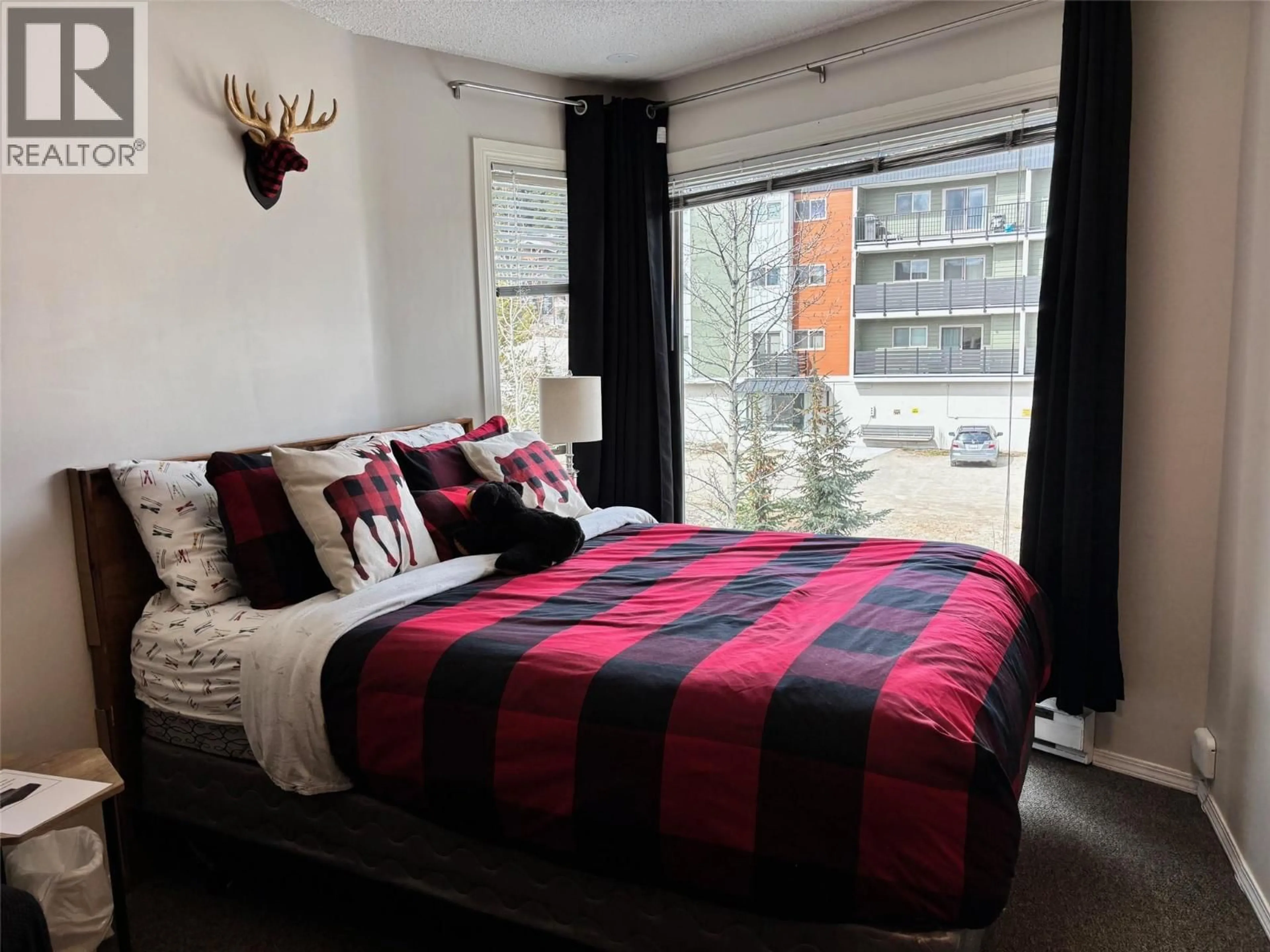 Bedroom with bed, wood/laminate floor for 306 BIG WHITE ROAD, Big White British Columbia V1Y6J6