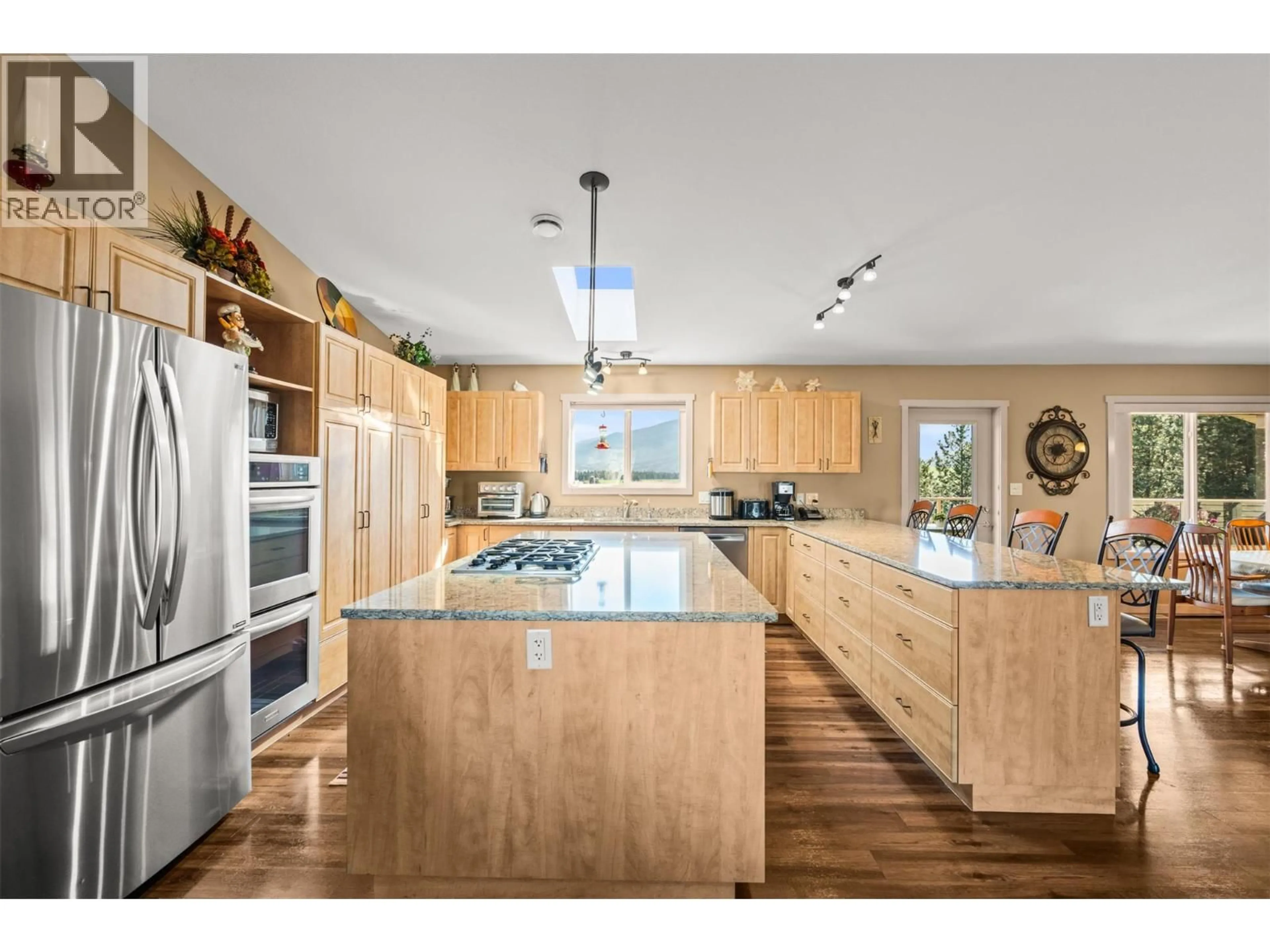 Open concept kitchen, wood/laminate floor for 84 - 9510 97 HIGHWAY NORTH, Vernon British Columbia V1H1R8