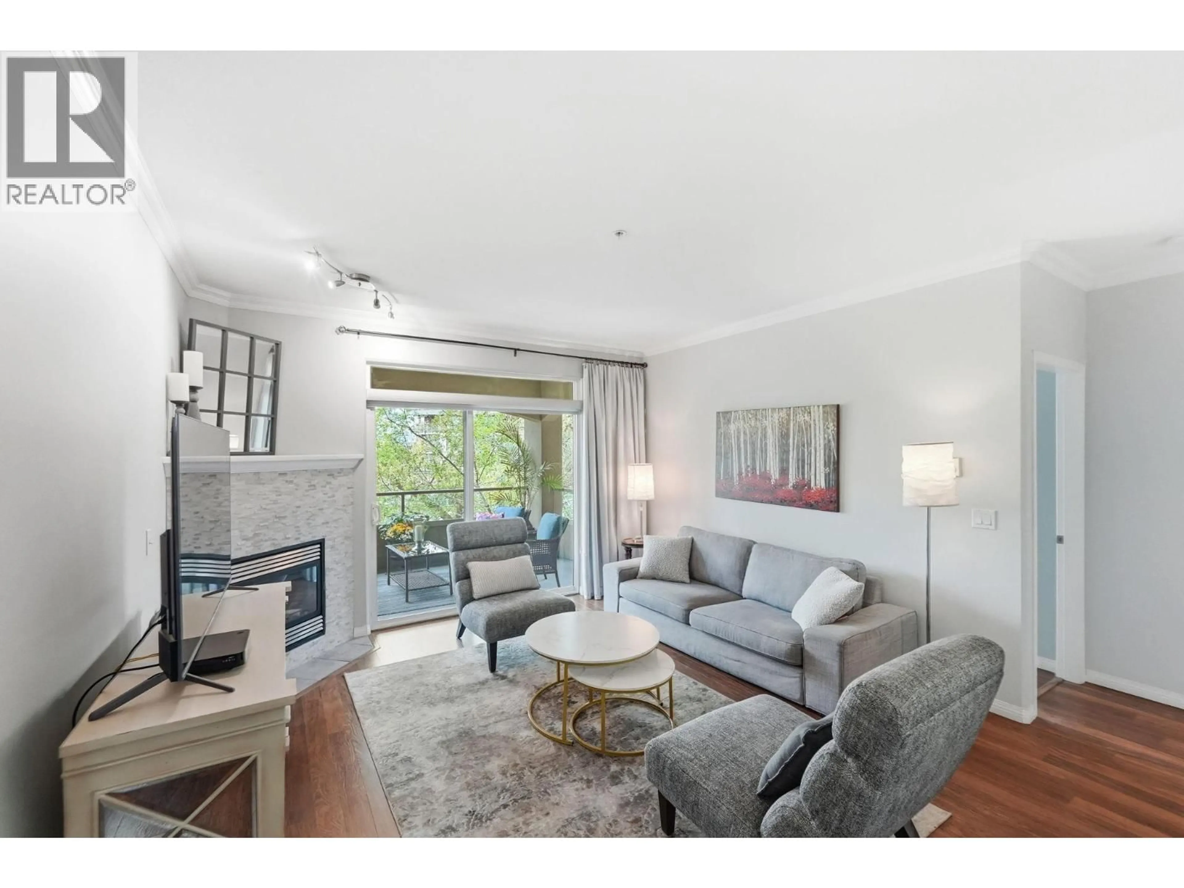 Living room with furniture, wood/laminate floor for 206 - 1960 ENTERPRISE WAY, Kelowna British Columbia V1Y9S5
