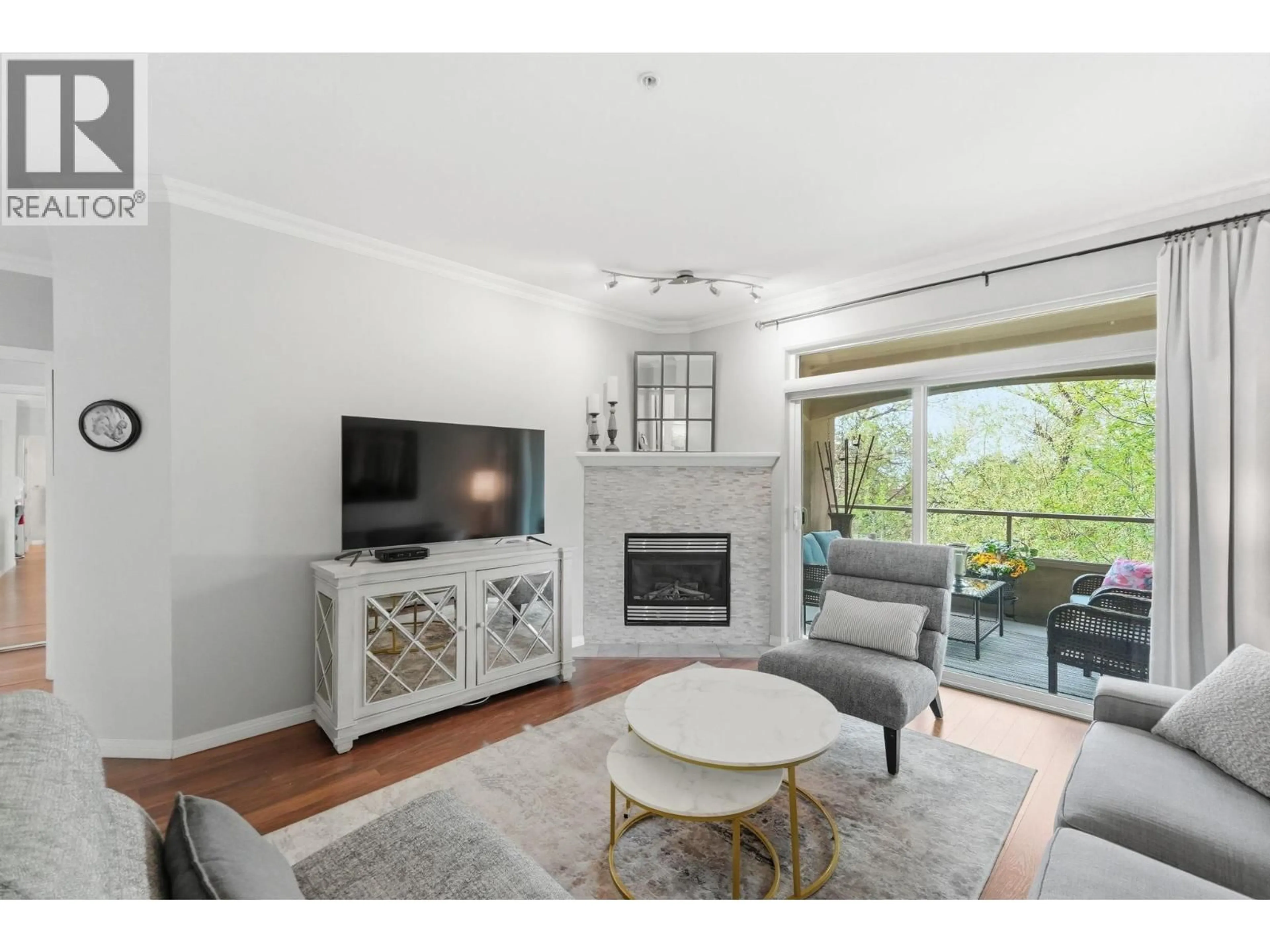 Living room with furniture, wood/laminate floor for 206 - 1960 ENTERPRISE WAY, Kelowna British Columbia V1Y9S5