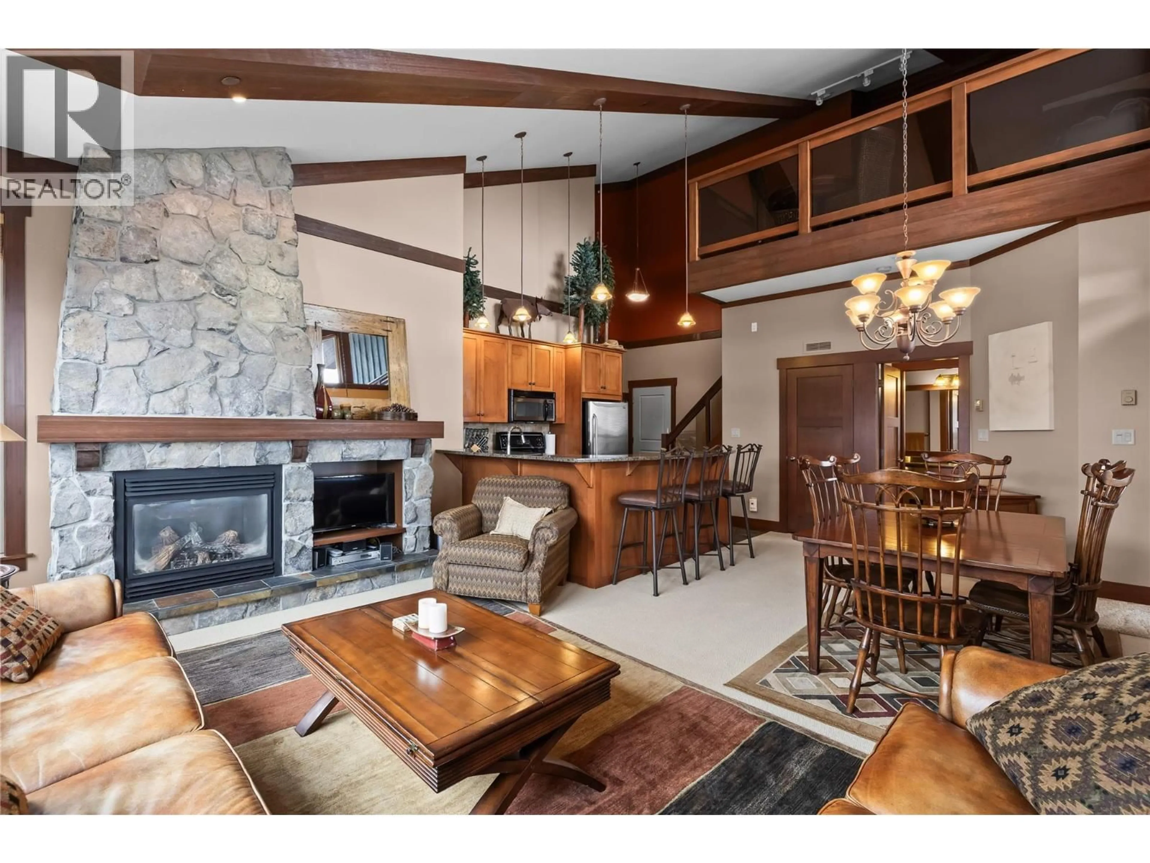 Living room with furniture, wood/laminate floor for 401 - 5259 BIG WHITE ROAD, Big White British Columbia V1P1P3