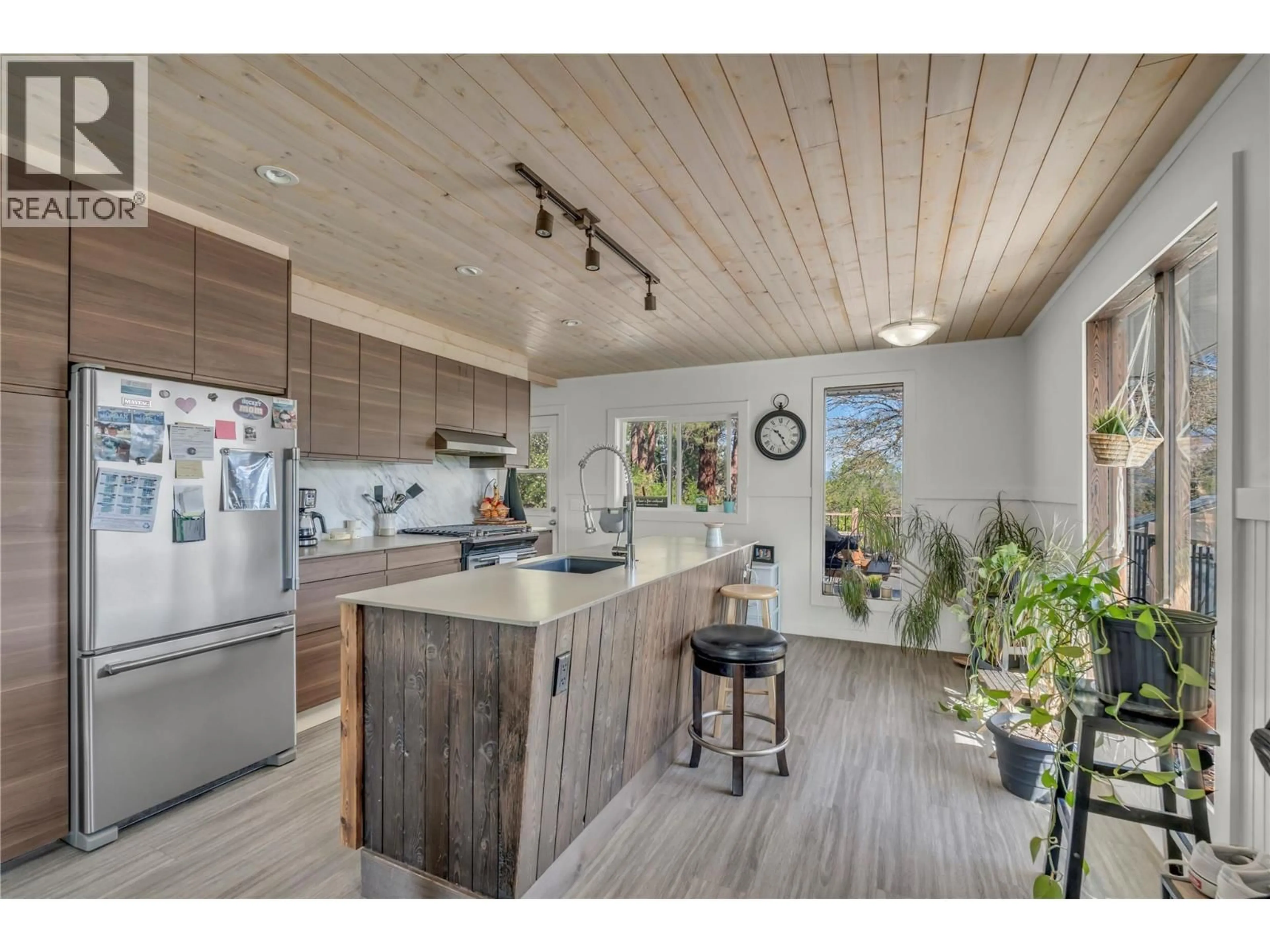 Open concept kitchen, wood/laminate floor for 3909 GARTRELL ROAD, Summerland British Columbia V0H1Z4