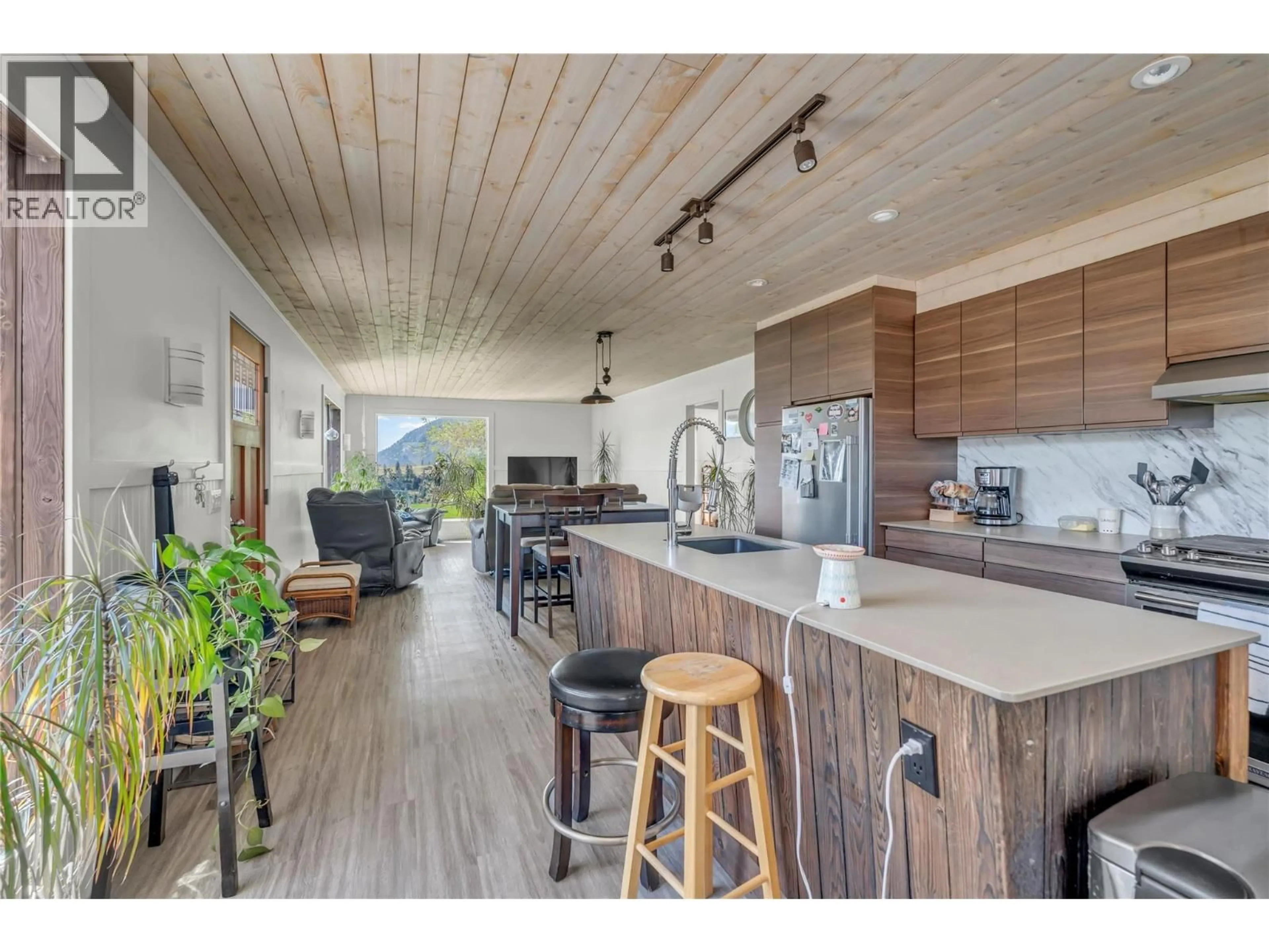 Open concept kitchen, wood/laminate floor for 3909 GARTRELL ROAD, Summerland British Columbia V0H1Z4