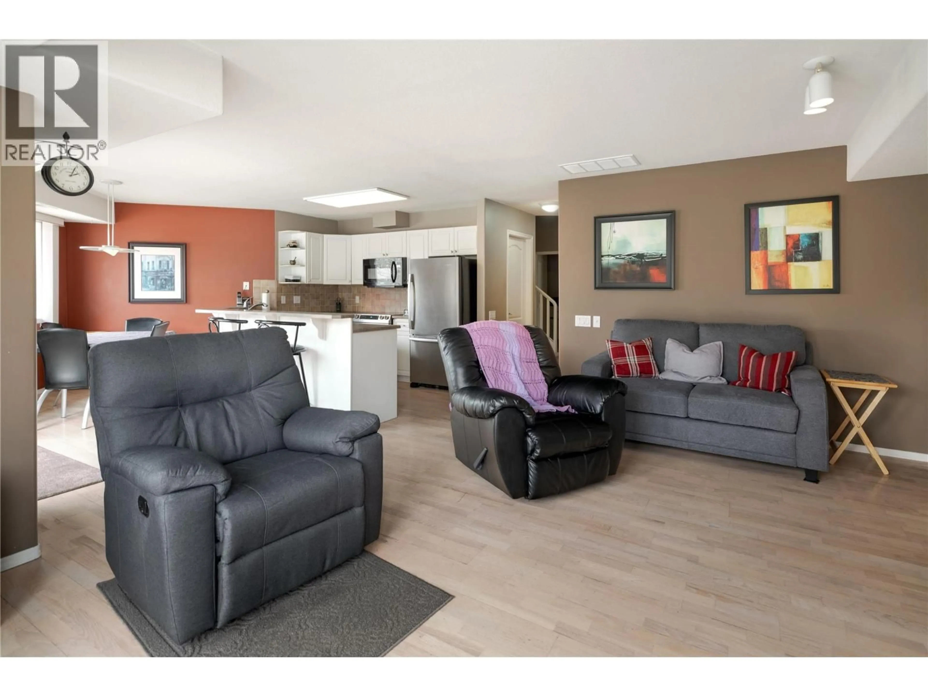 Living room with furniture, wood/laminate floor for 115 - 980 DILWORTH DRIVE, Kelowna British Columbia V1V1S6