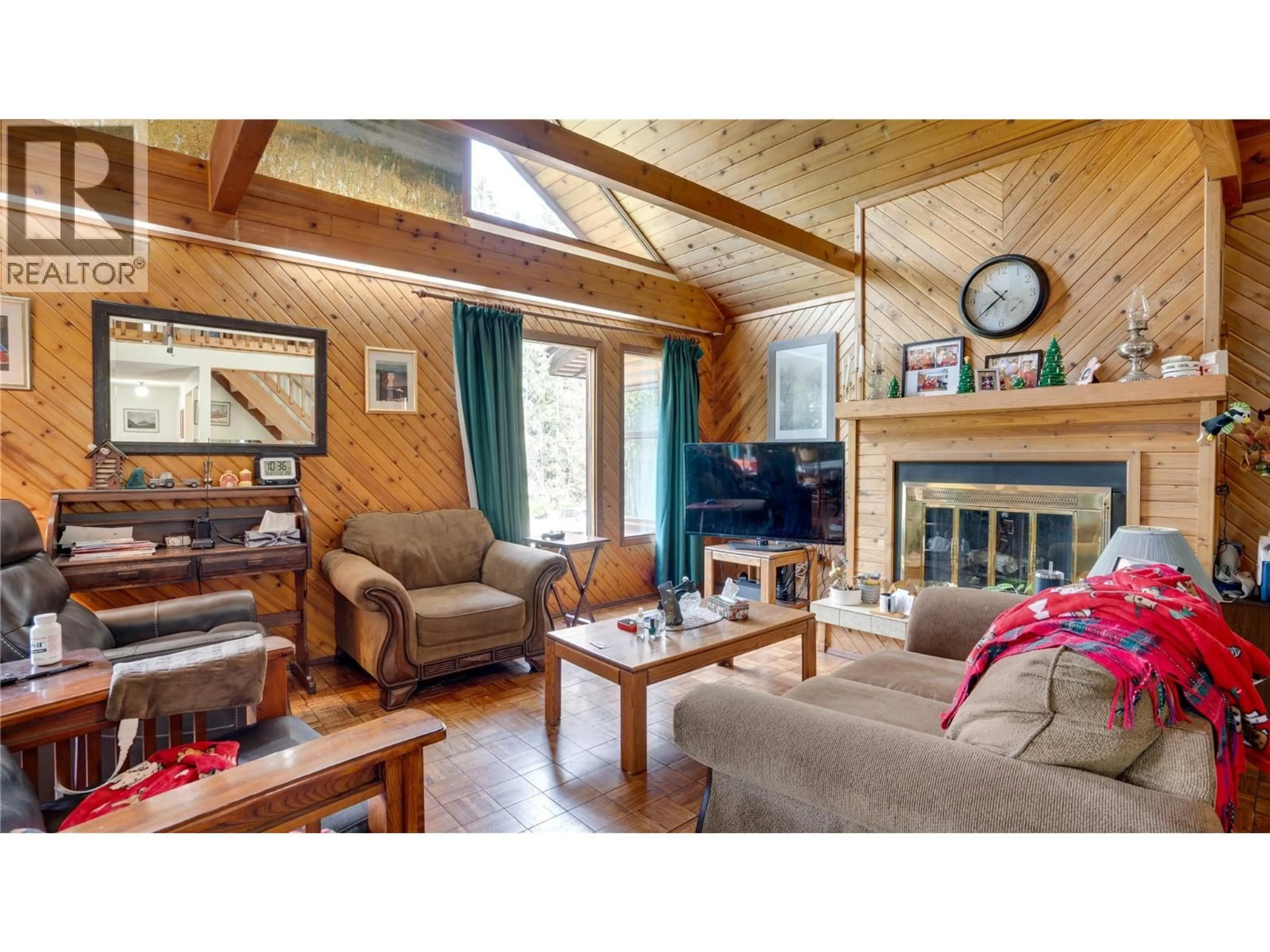 Living room with furniture, wood/laminate floor for 5677 BRENTWOOD ROAD, Vernon British Columbia V1B3K1