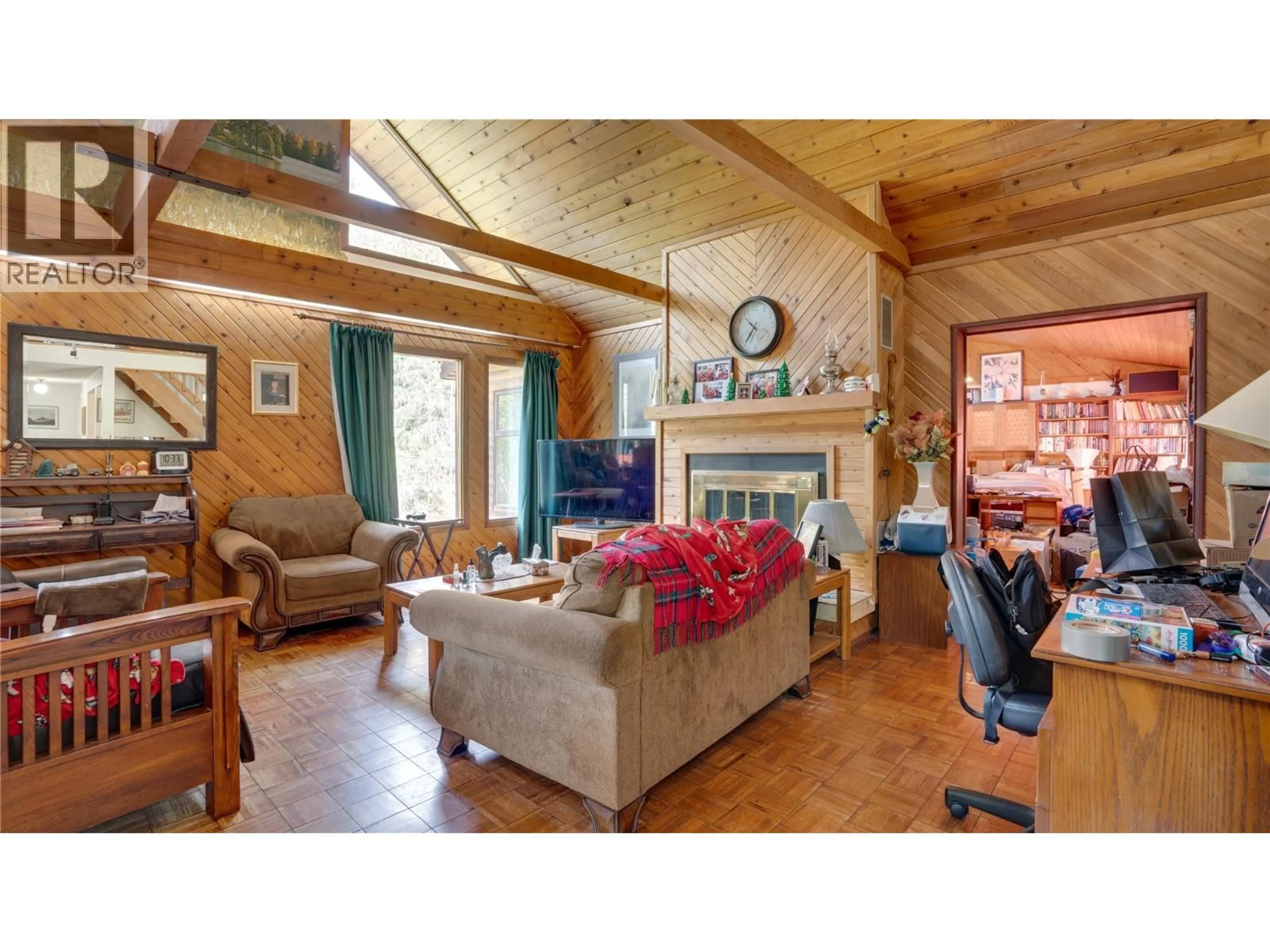 Living room with furniture, wood/laminate floor for 5677 BRENTWOOD ROAD, Vernon British Columbia V1B3K1