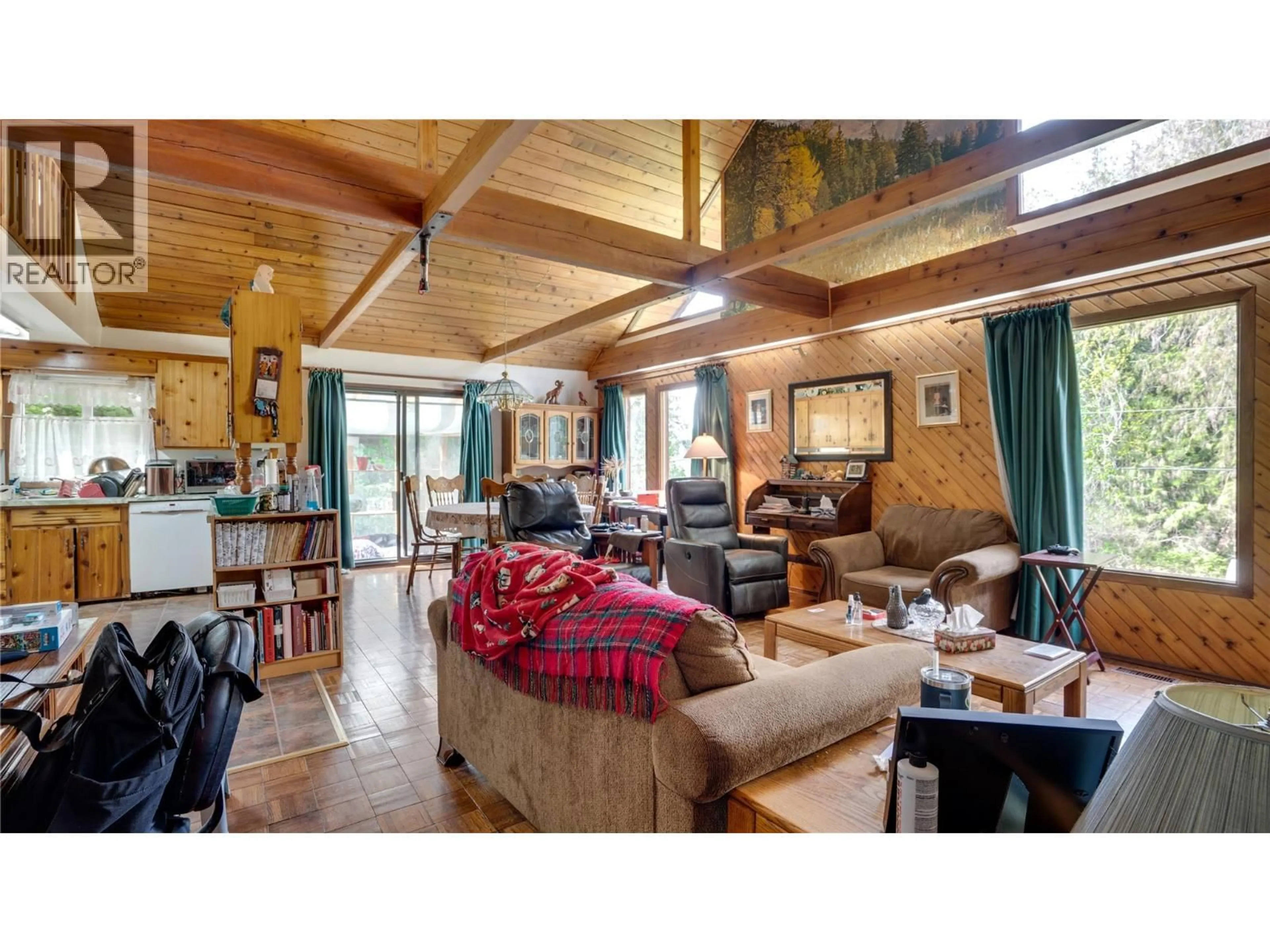 Living room with furniture, wood/laminate floor for 5677 BRENTWOOD ROAD, Vernon British Columbia V1B3K1