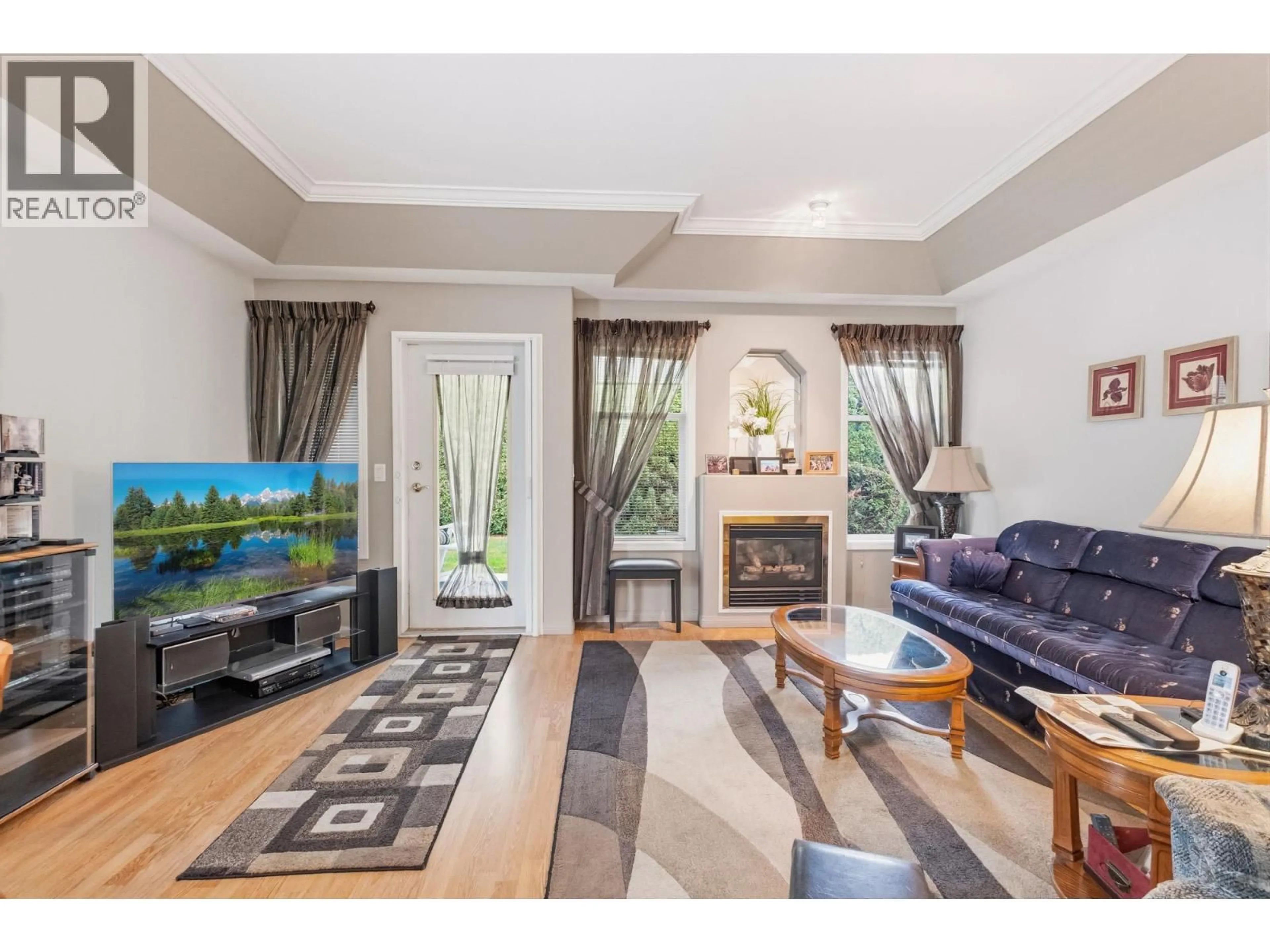 Living room with furniture, wood/laminate floor for 111 - 1330 RIDGEWAY DRIVE, Kelowna British Columbia V1Y9T8