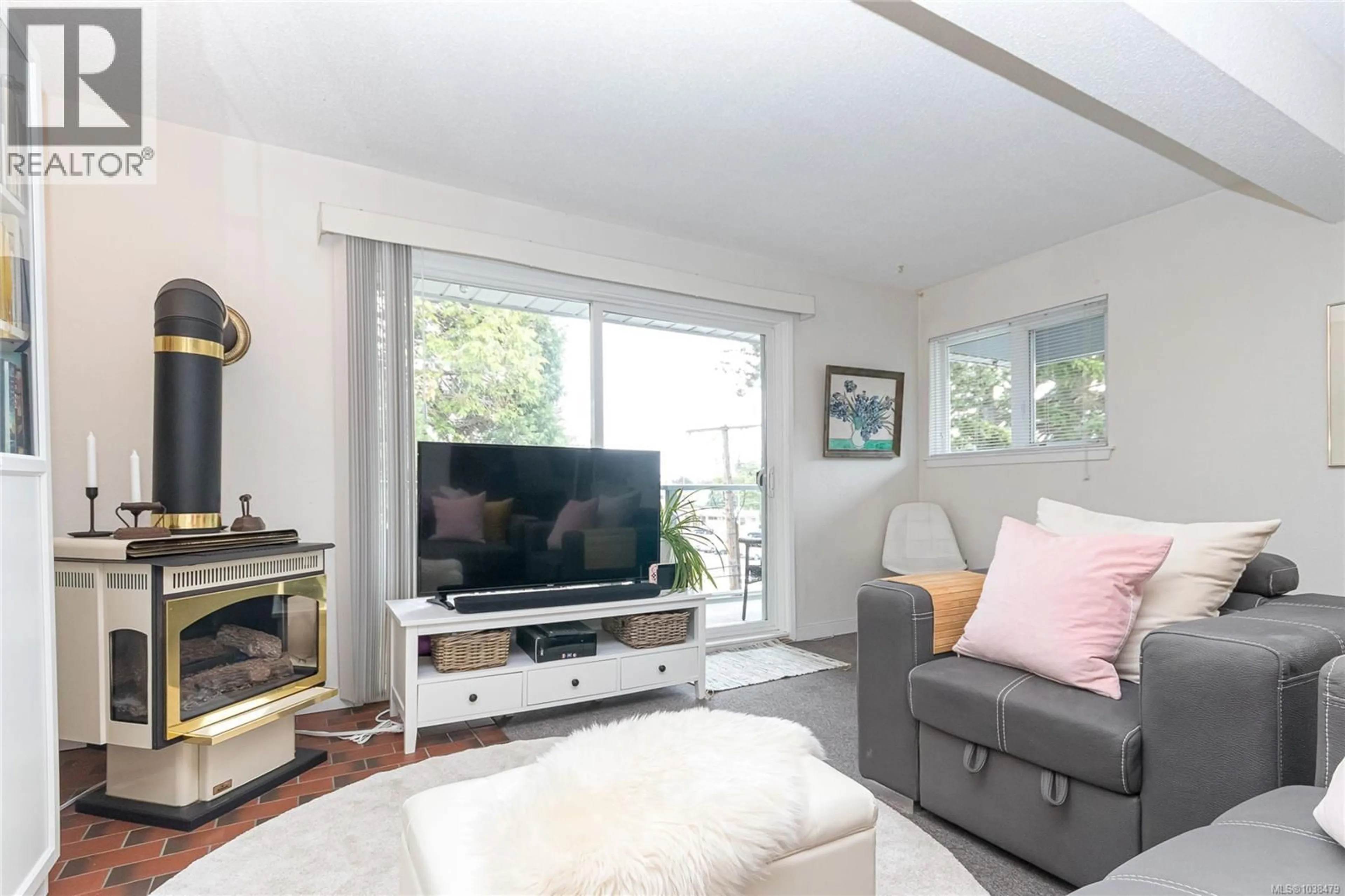 Living room with furniture, wood/laminate floor for 411 - 2022 FOUL BAY ROAD, Victoria British Columbia V8R5A9