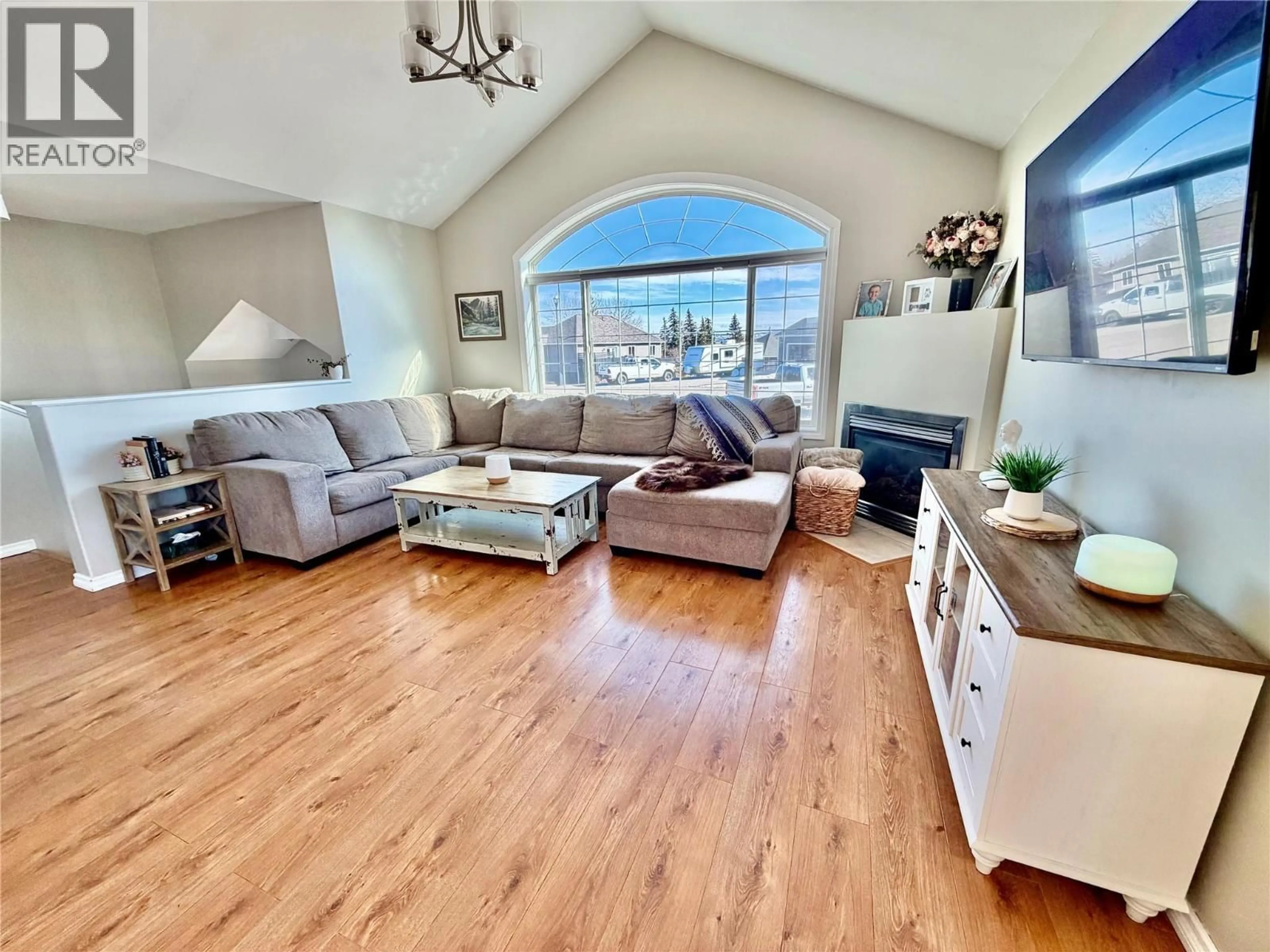 Living room with furniture, wood/laminate floor for 1904 91 AVENUE, Dawson Creek British Columbia V1G4E3